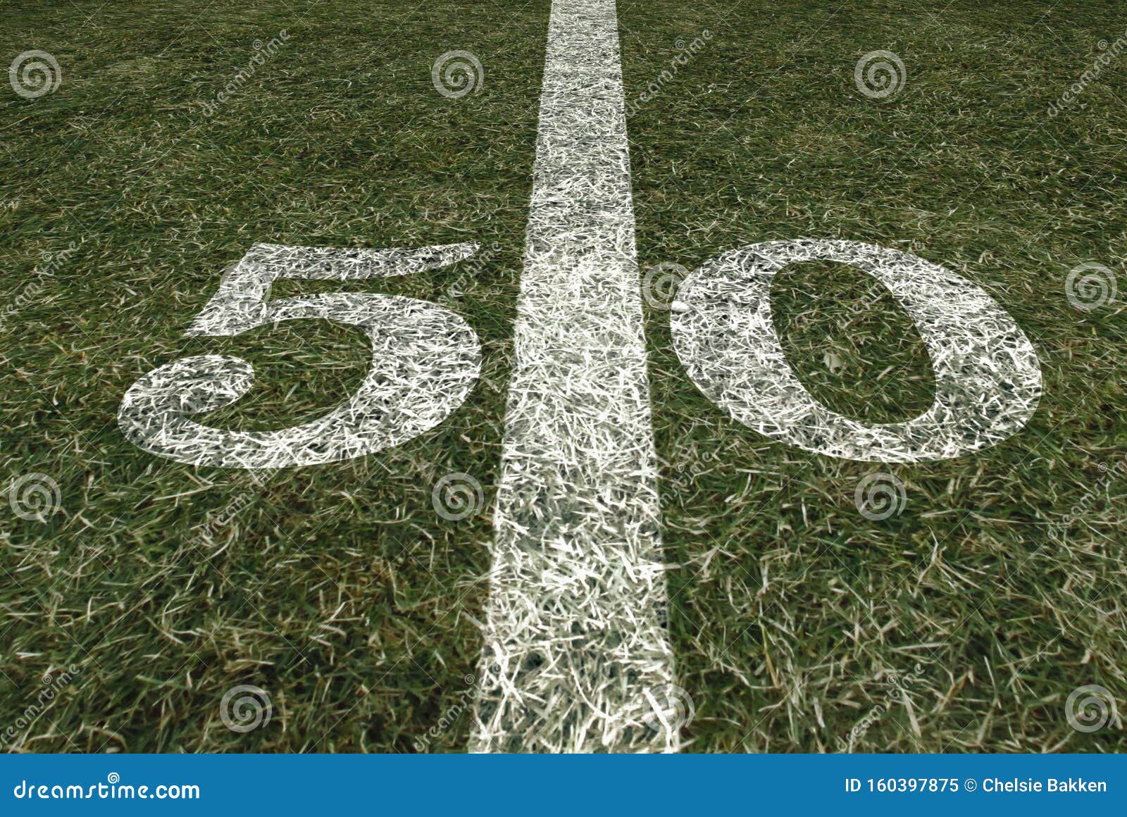 Friday Night Lights Football Game on Football Field Fifty Yard Line