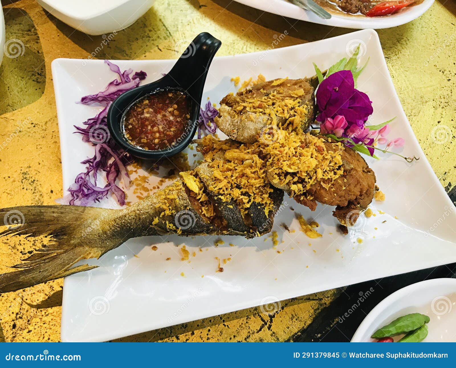 fried blacked-banded trevally with garlic in thailand.