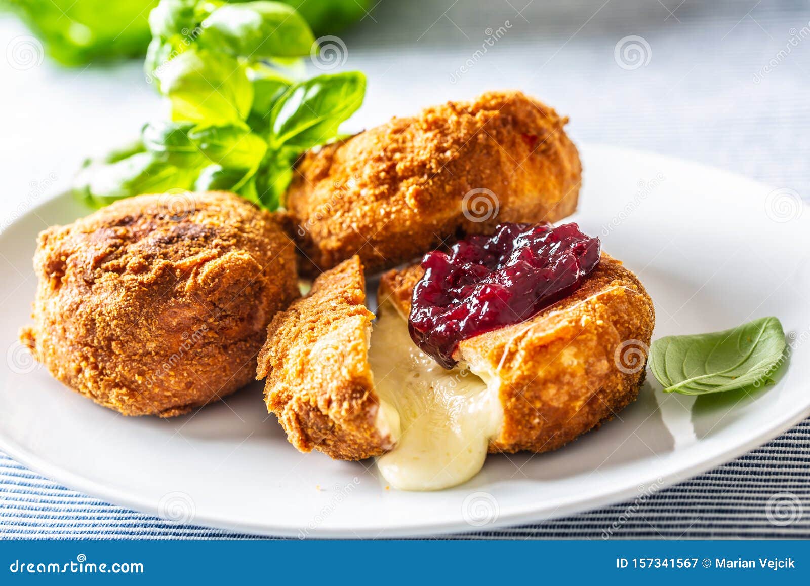 Fried Camembert or Brie Cheese with Cranberry Jam and Basil Stock Image
