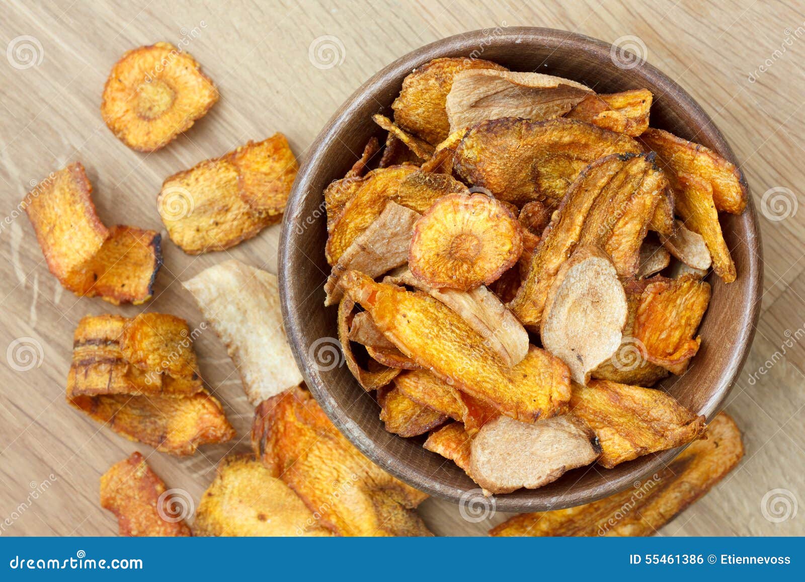 Fried Carrot and Parsnip Chips in Rustic Wood Bowl. from Above. Stock