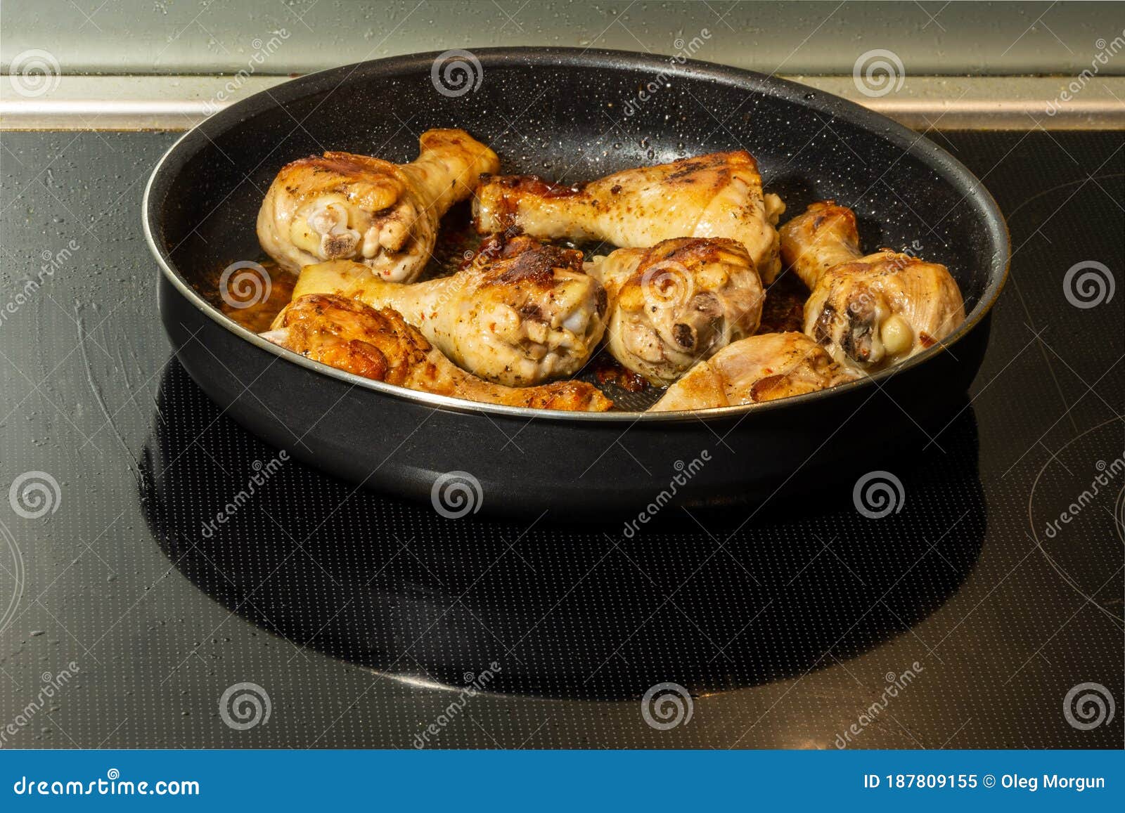 Fried Chicken Legs with Herbs and Spices in a Frying Pan Stock Image