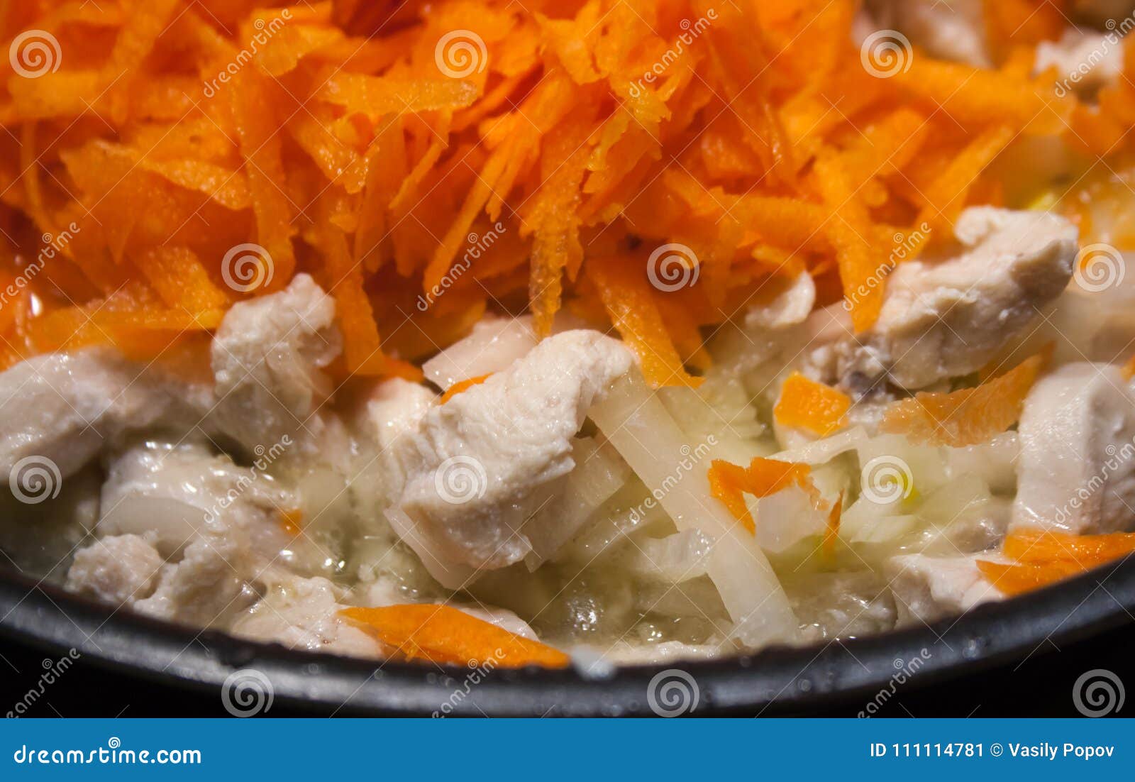 Fried Chicken with Onions and Carrots in a Frying Pan Stock Image