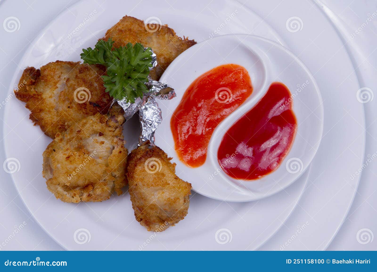 Fried Chicken Thighs with Tomato Sauce and Chili Sauce Stock Photo