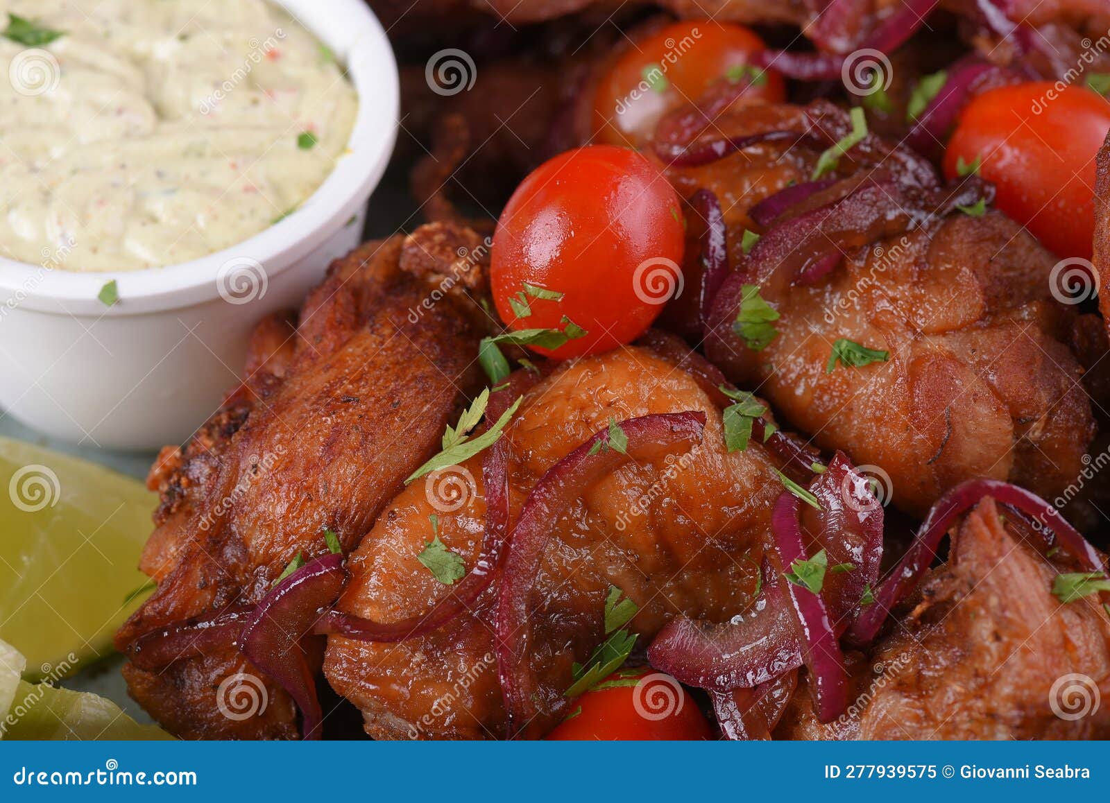 Fried Chicken with Tomatoes and Caramelized Onions Wings with Herb Sauce Stock Image Image of