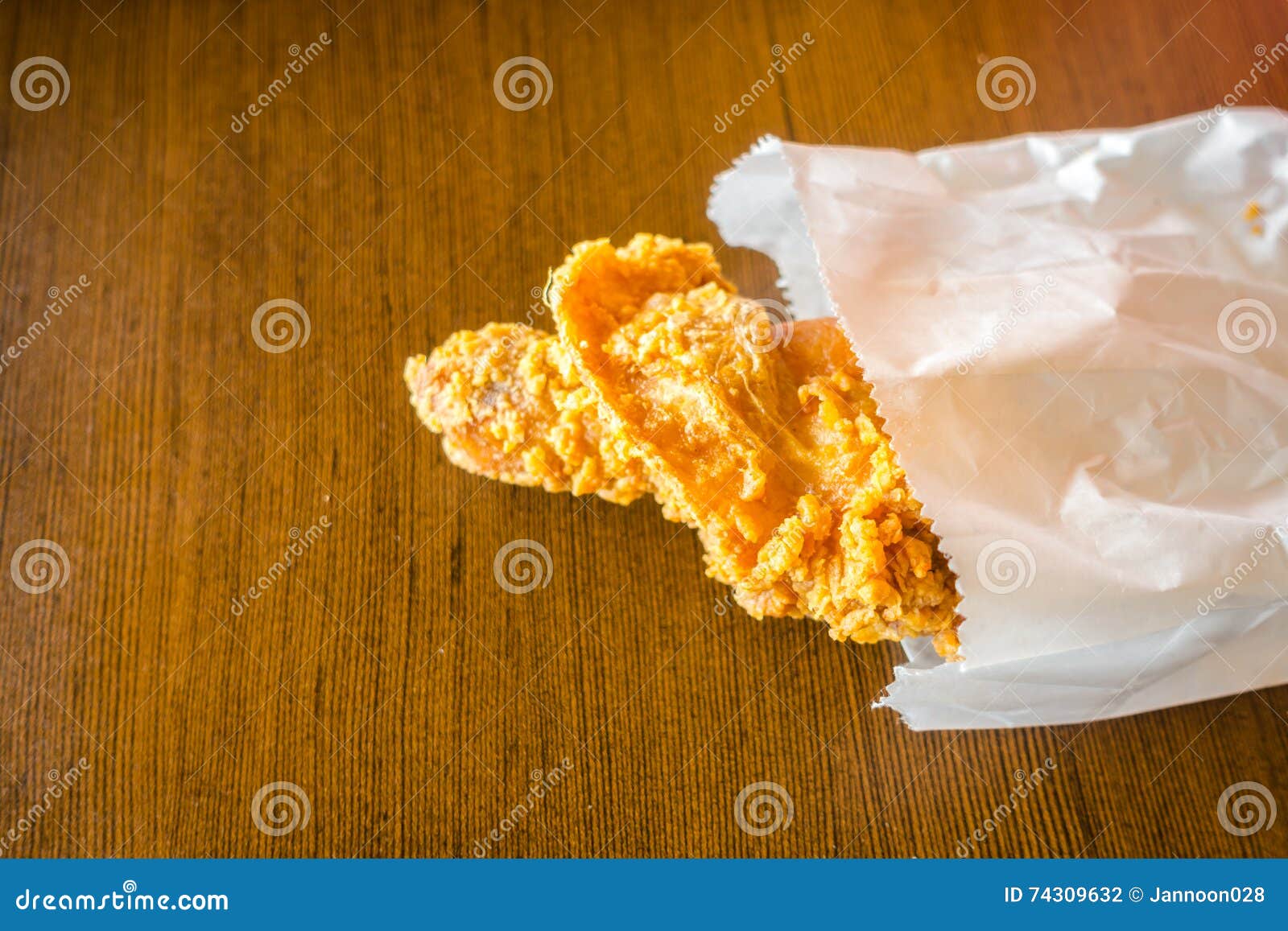 Fried Chicken Wings in Paper Bag on Wood Table . Stock Photo Image of
