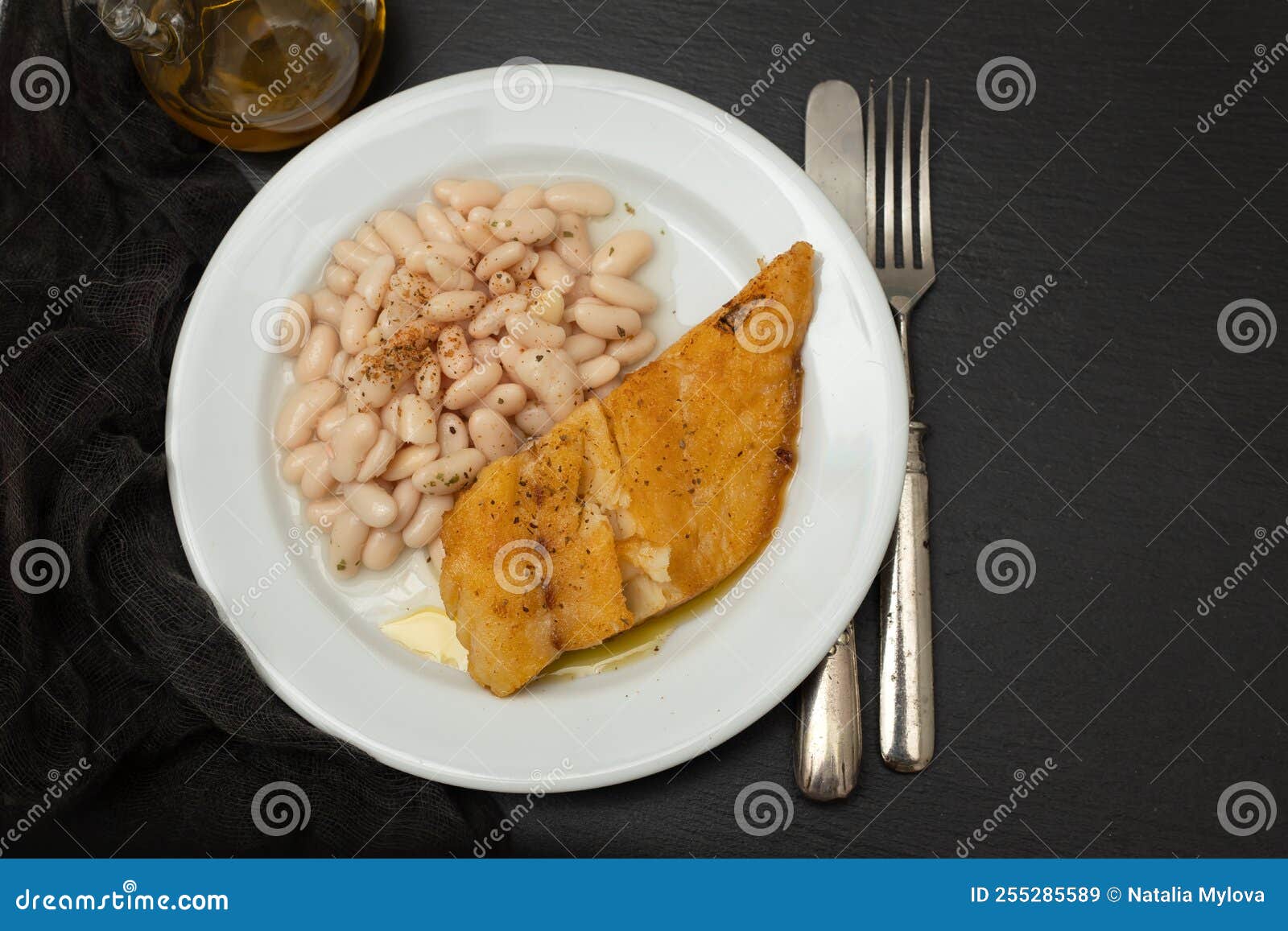 Fried Cod Fish with White Beans on the Plate. Stock Image Image of