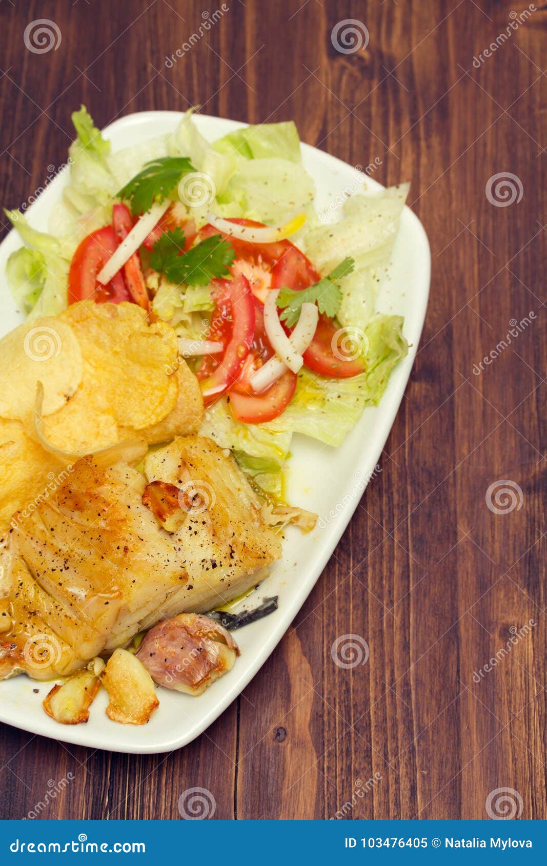 Fried Codfish with Potato and Salad on Dish Stock Image - Image of ...