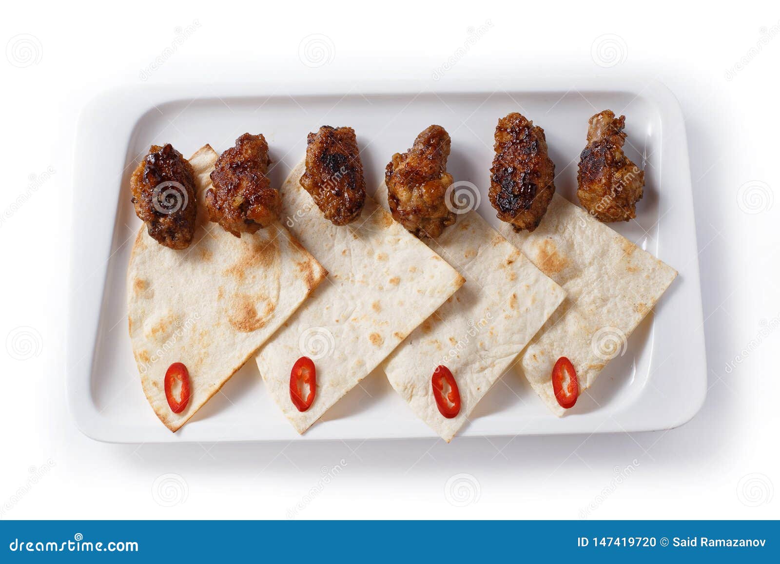 Fried Cuts of Meat and Thin Wheat Bread in a White Plate on an Isolated