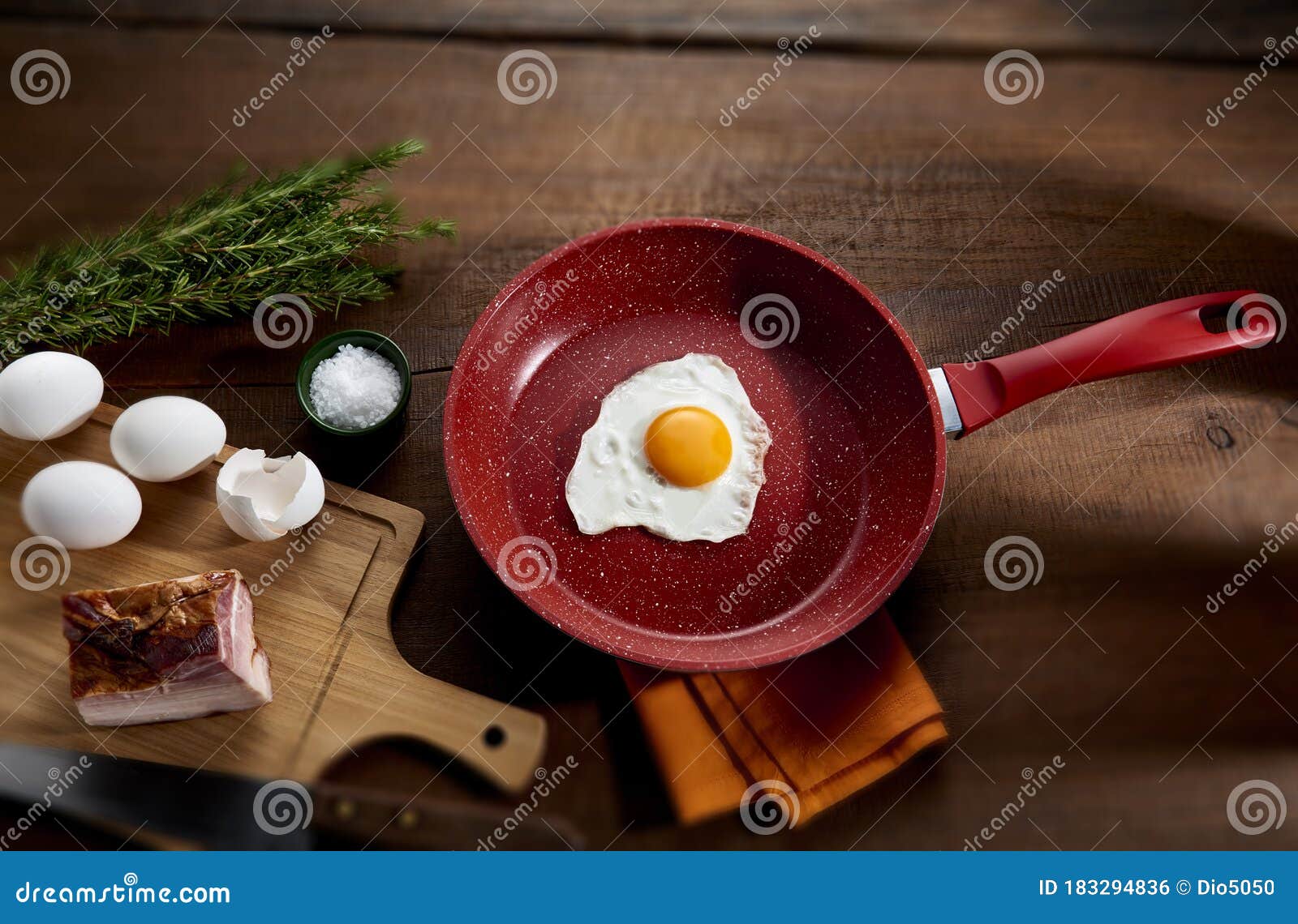 fried egg in red frying pan