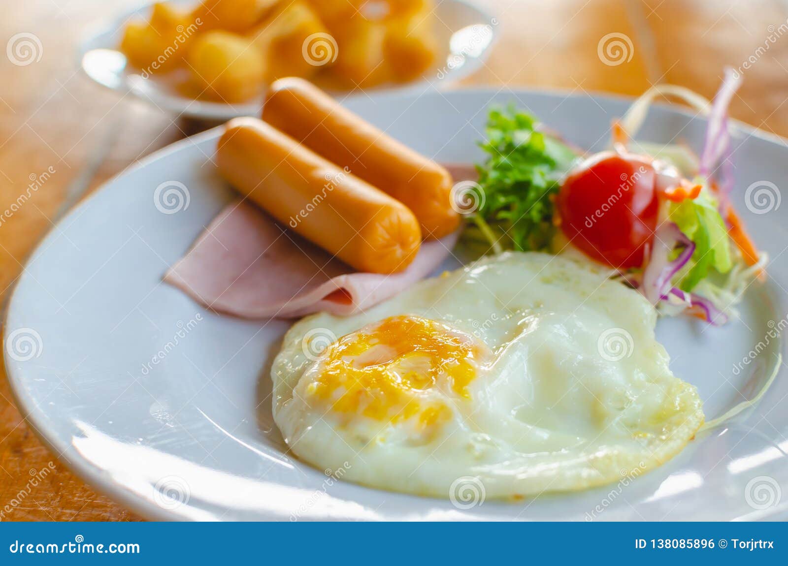 Fried Egg with Sausage and Ham Served with Vegetable Salad for