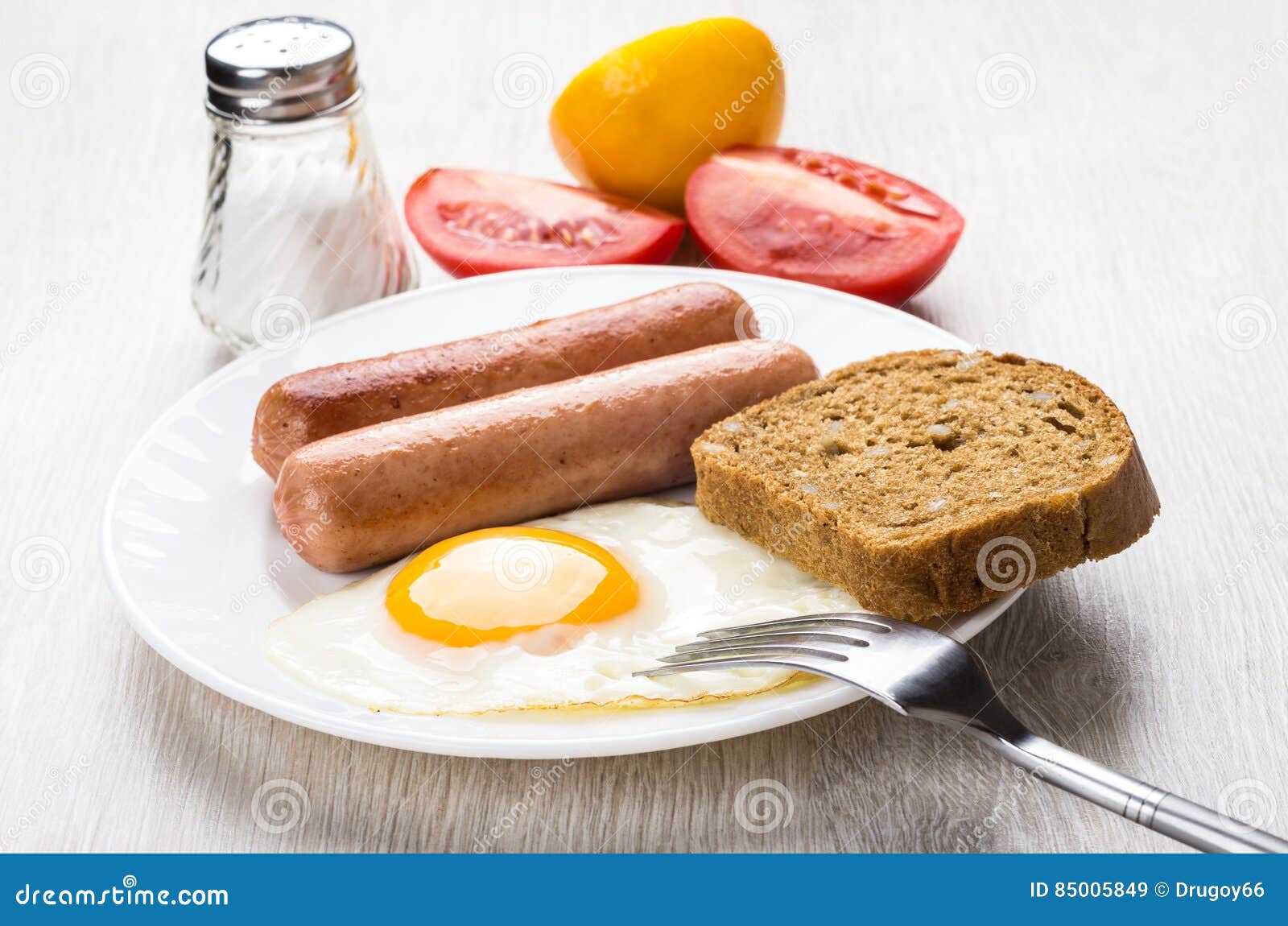 Fried Egg, Sausages and Bread in Plate, Salt, Tomato Stock Image