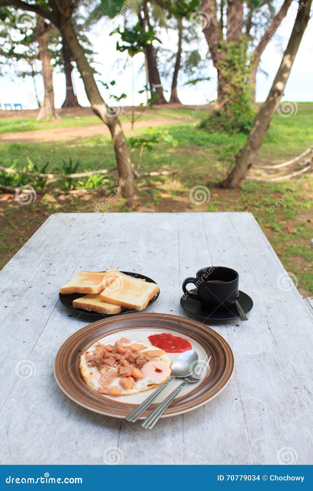 Fried Egg, Strawberry Jam Bread Toast And Black Cup Of 