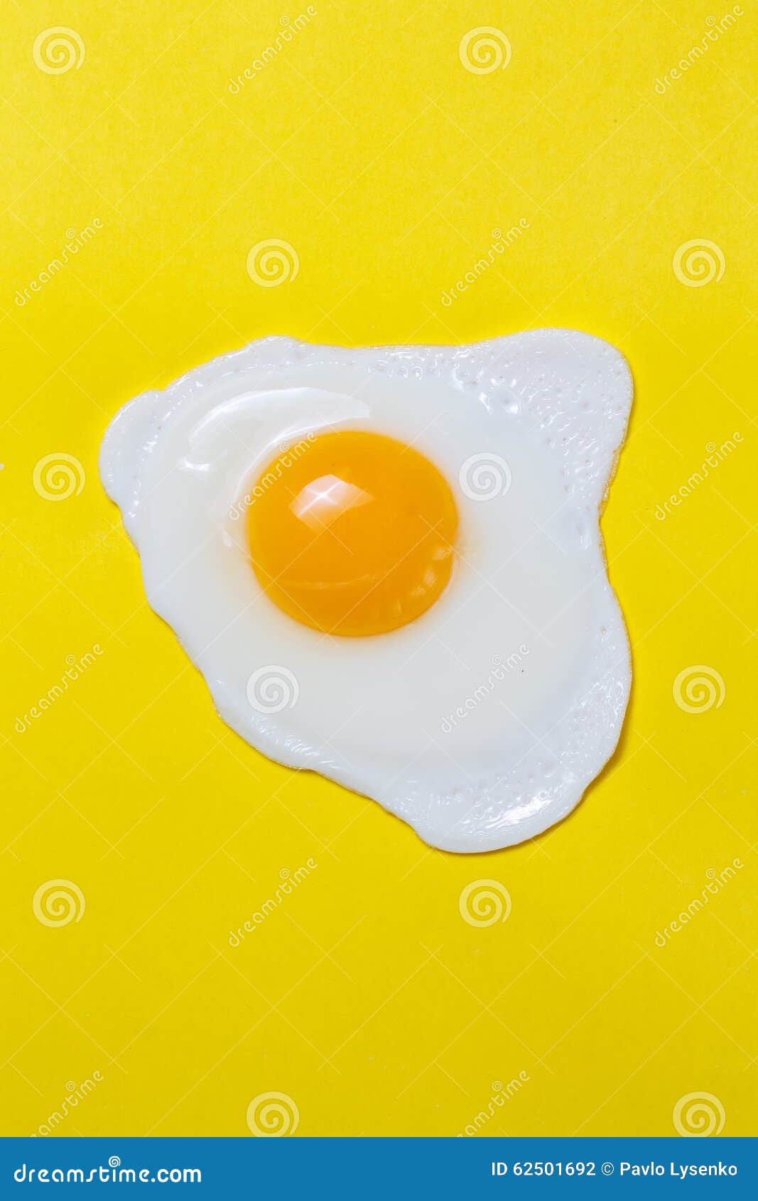 Fried Egg on a Yellow Background with Black Pepper Stock Photo Image