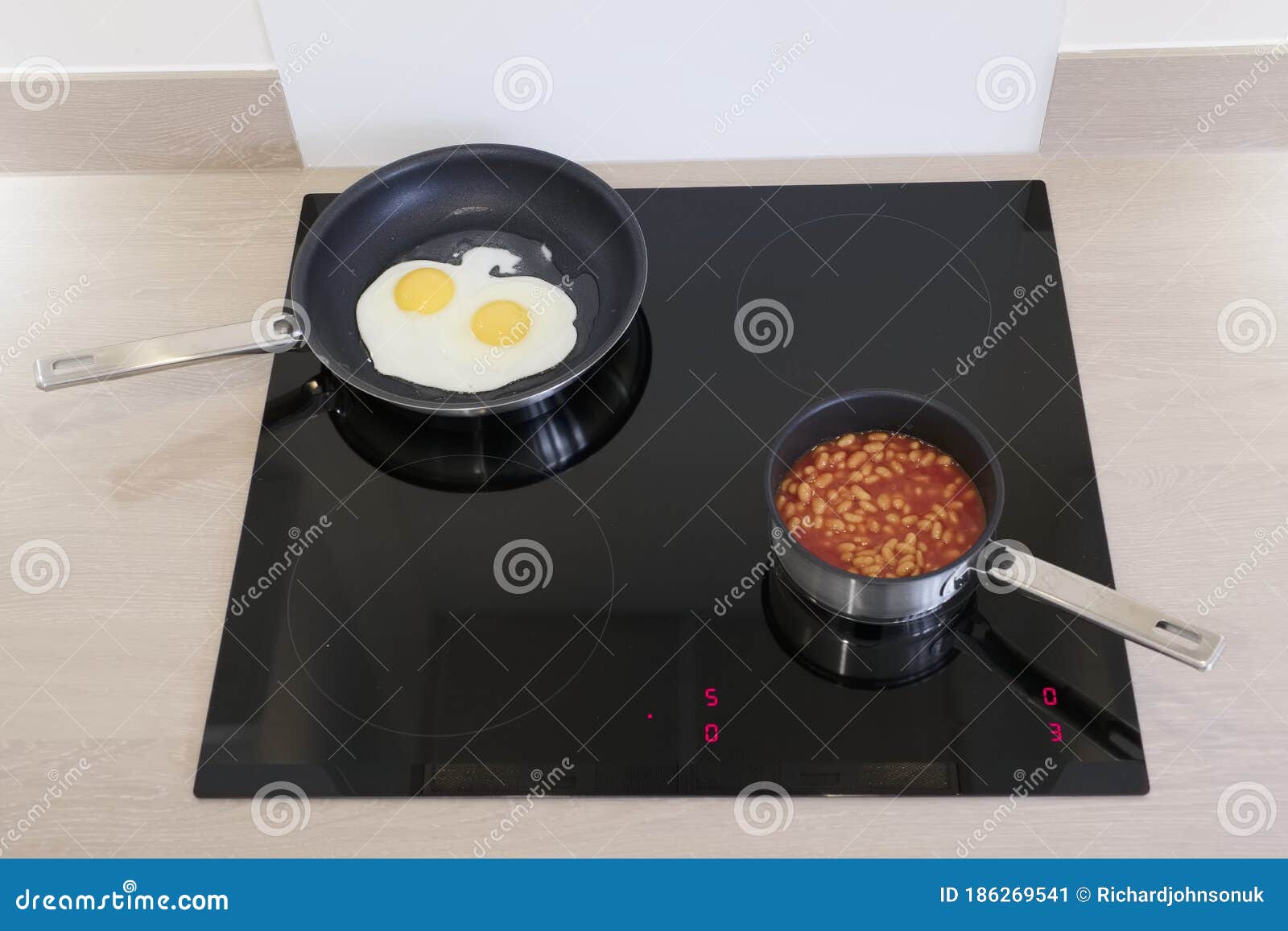 Fried Eggs and Baked Beans Cooking Induction Hob Stock Image Image of