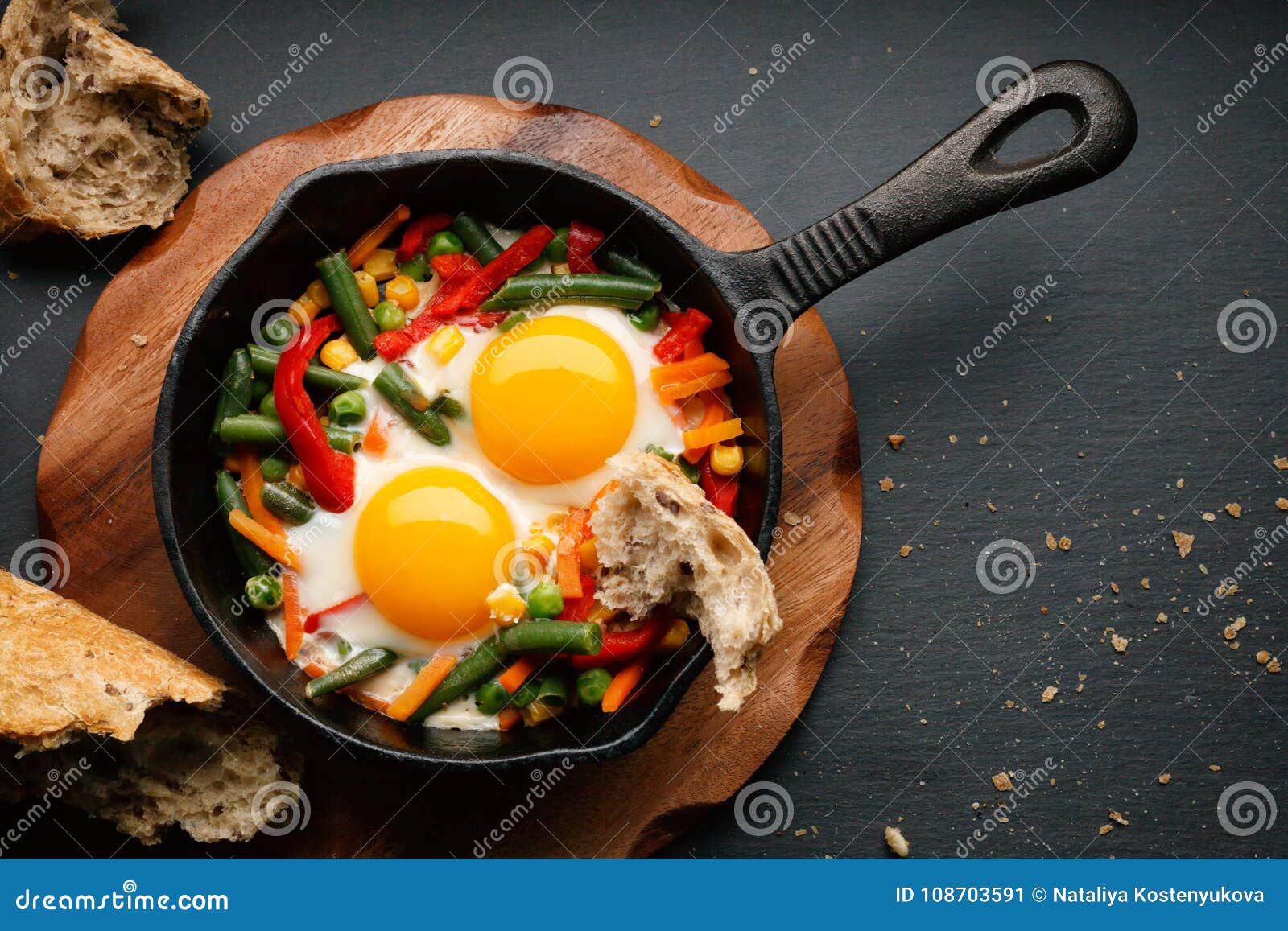 Fried eggs in a cast iron stock image. Image of bread 108703591