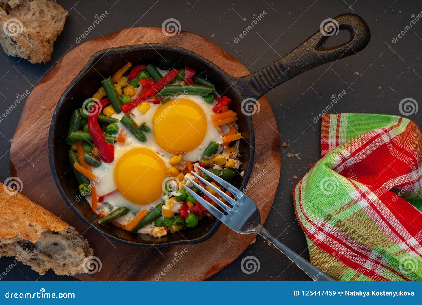 Fried eggs in a cast iron stock image. Image of cast 125447459