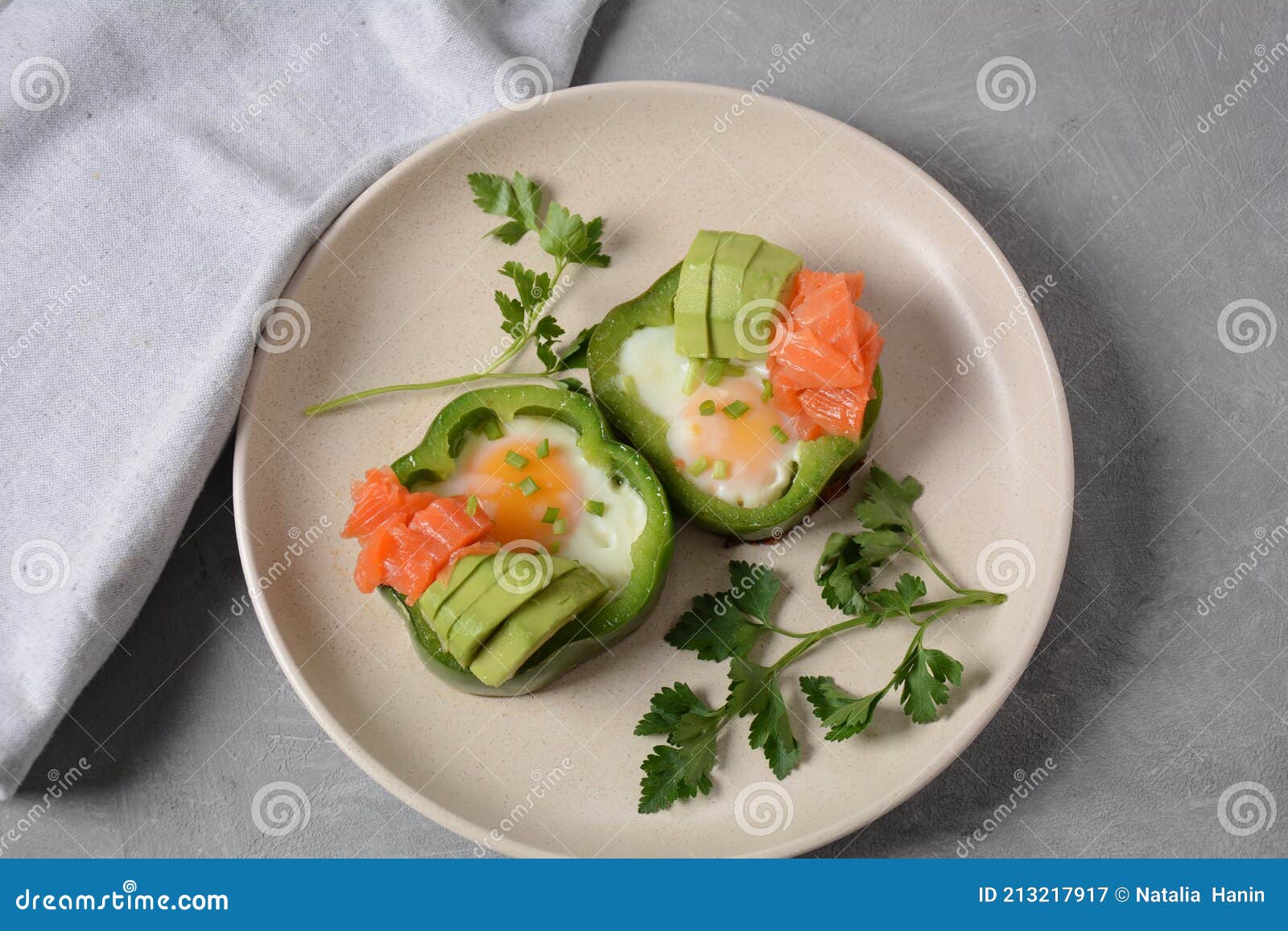 Fried Eggs in Green Bell Peppers with Avocado and Salmon Stock Image