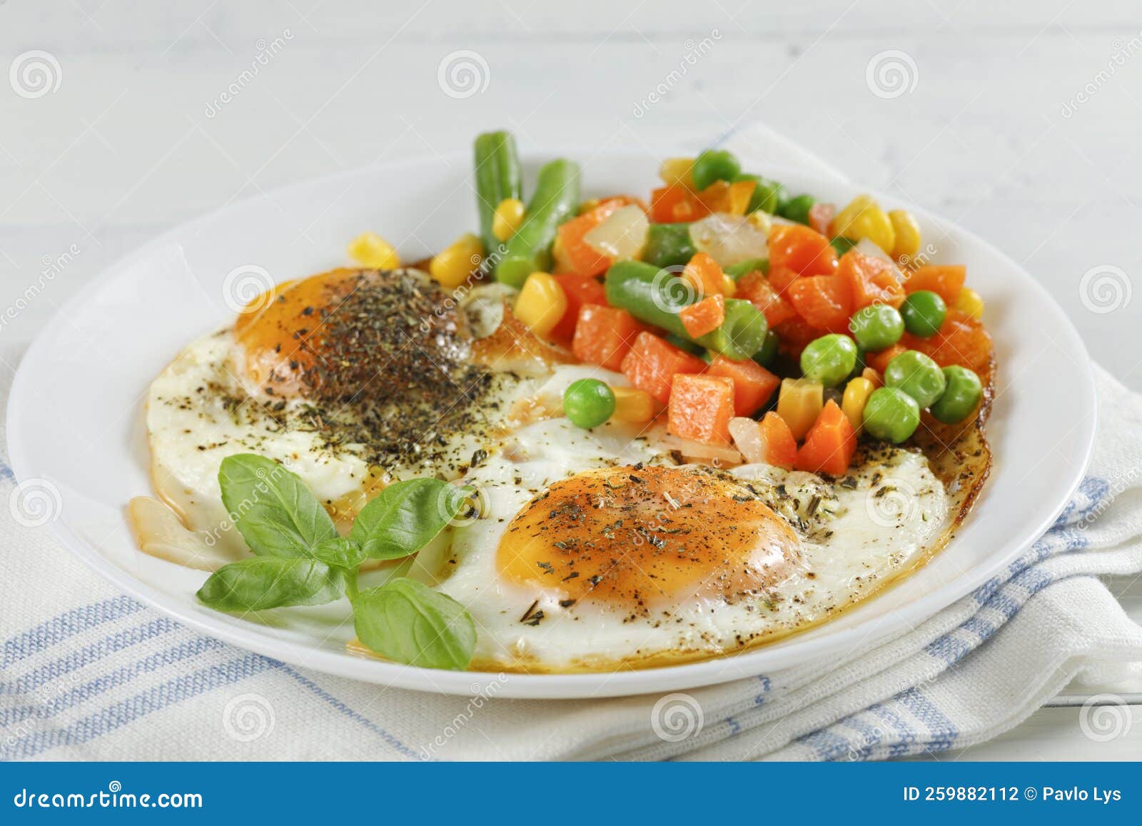 Fried Eggs with Vegetables. Traditional Delicious Breakfast and Lunch