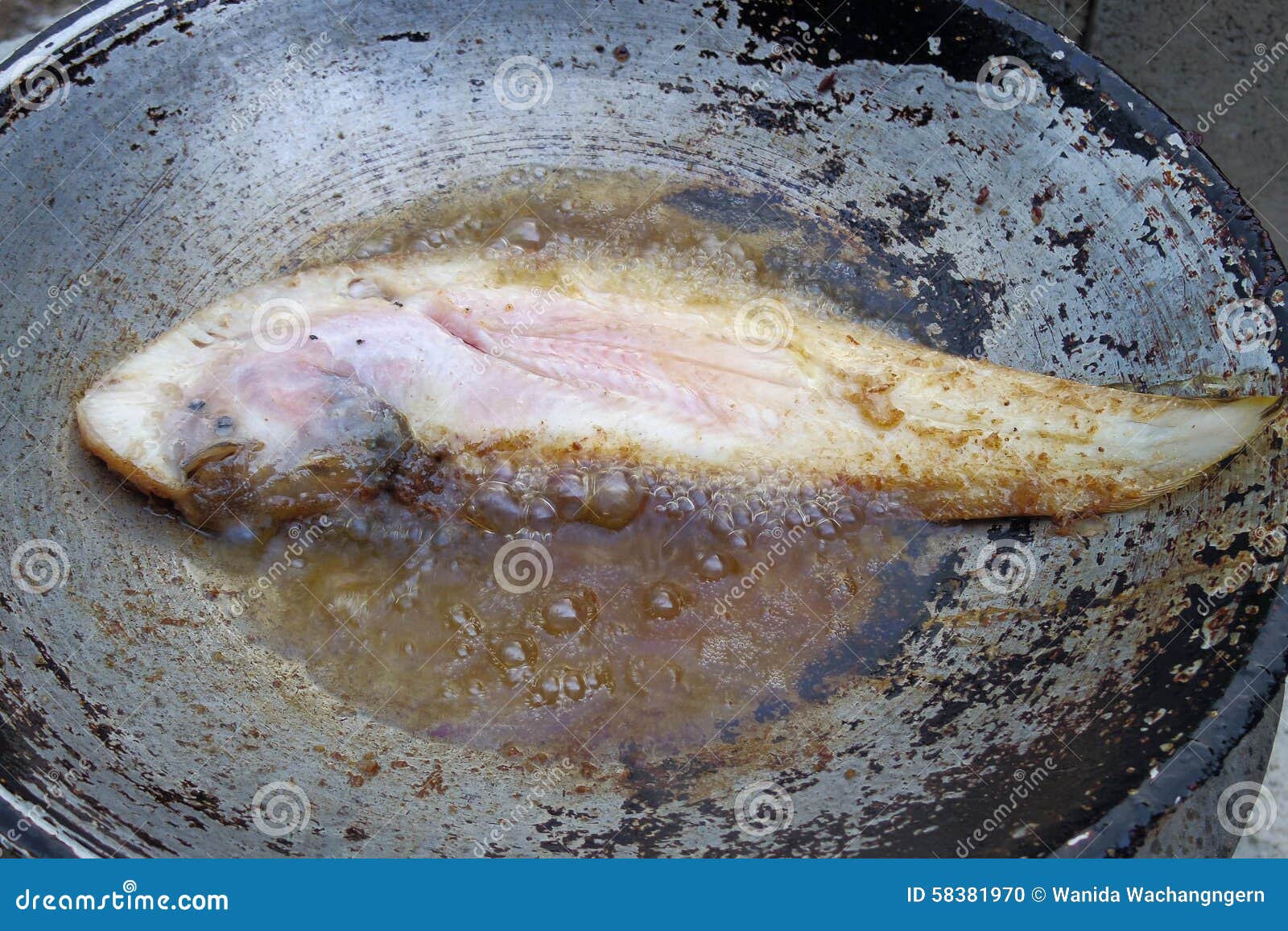 Fried fish on boiling oil stock photo. Image of cuisine 58381970