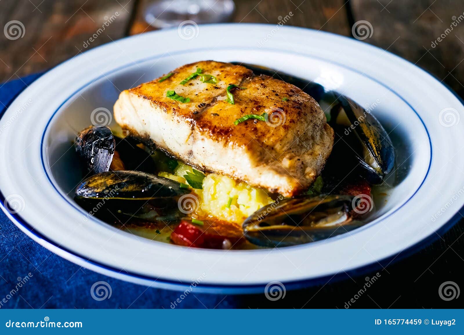 Fried Fish Fillet with Mussels in Plate on the Table Stock Image