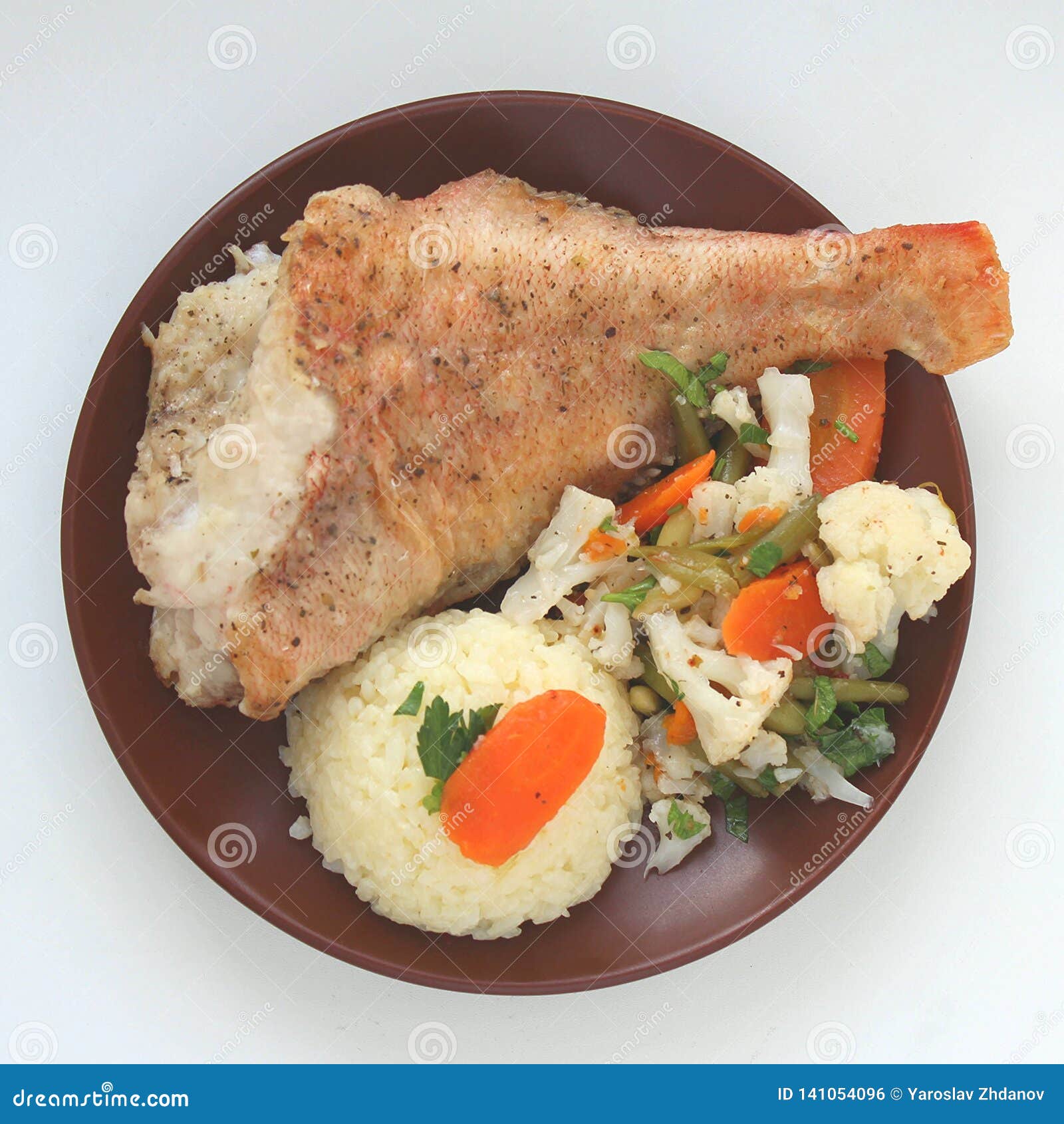 Fried Fish with Rice and Vegetables on a Plate Stock Photo - Image of