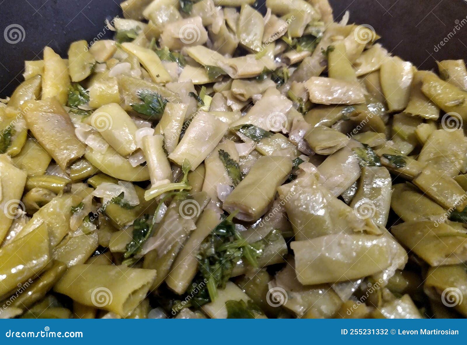 Fried Green Beans with Herbs in a Pan Closeup Photo. Stock Photo