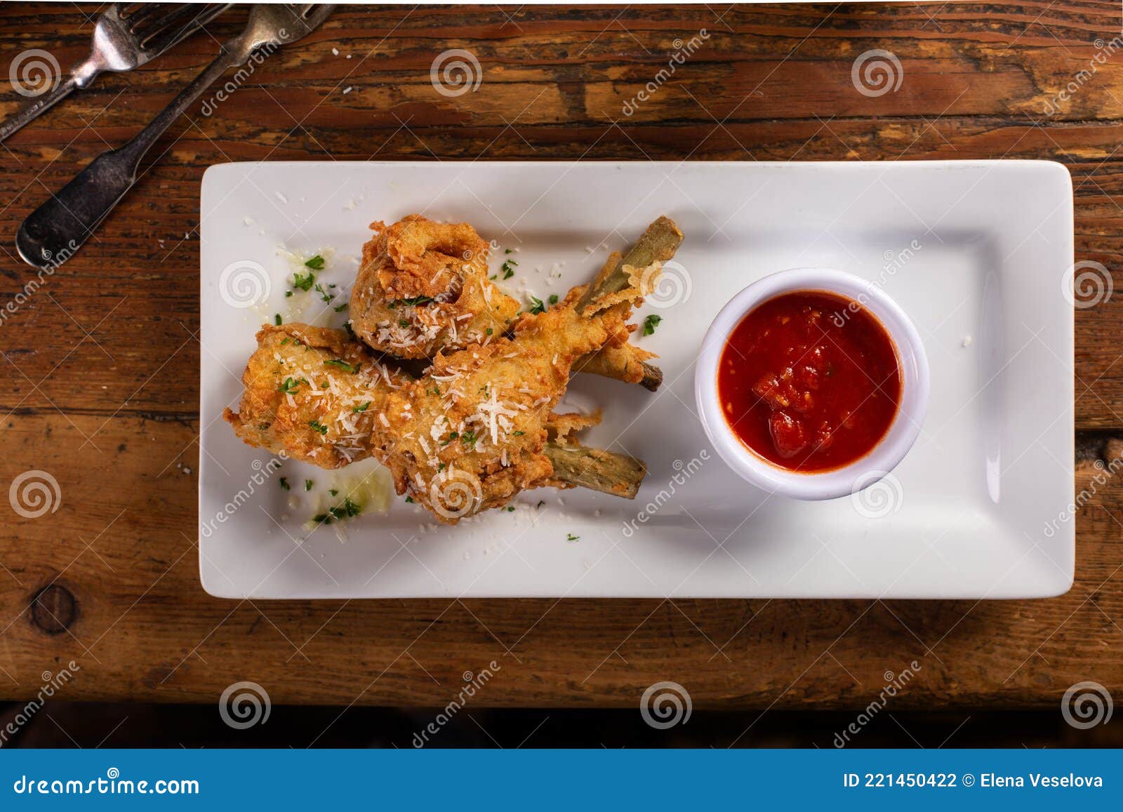 Fried Lamb Chops in Parmesan Batter with Tomato Sauce Stock Photo