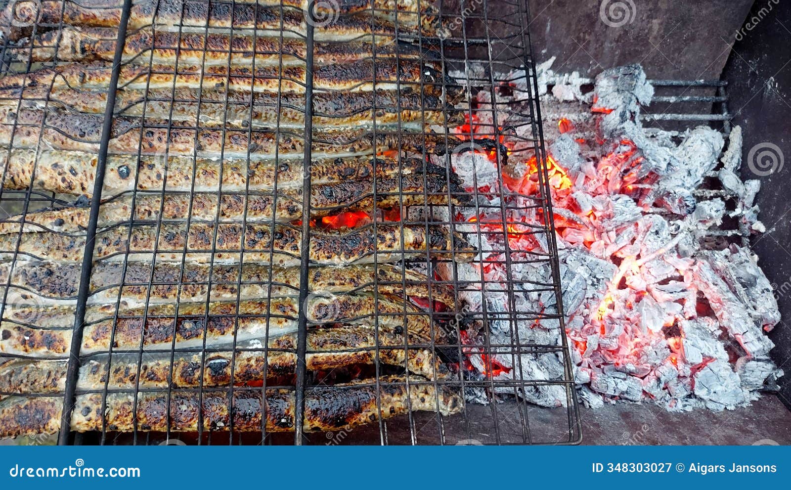 fried lampreys on the charcoal grill grates.