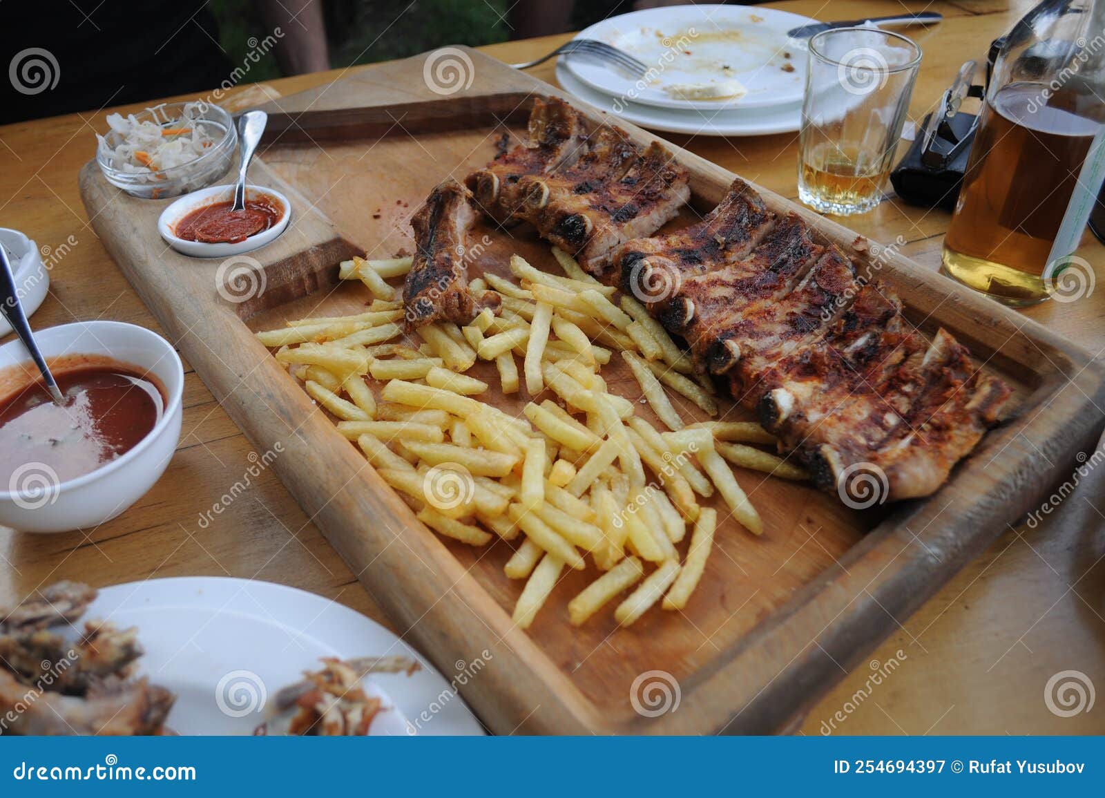 Fried Pork Ribs in Earthenware in the Oven with Garnish. Stock Image