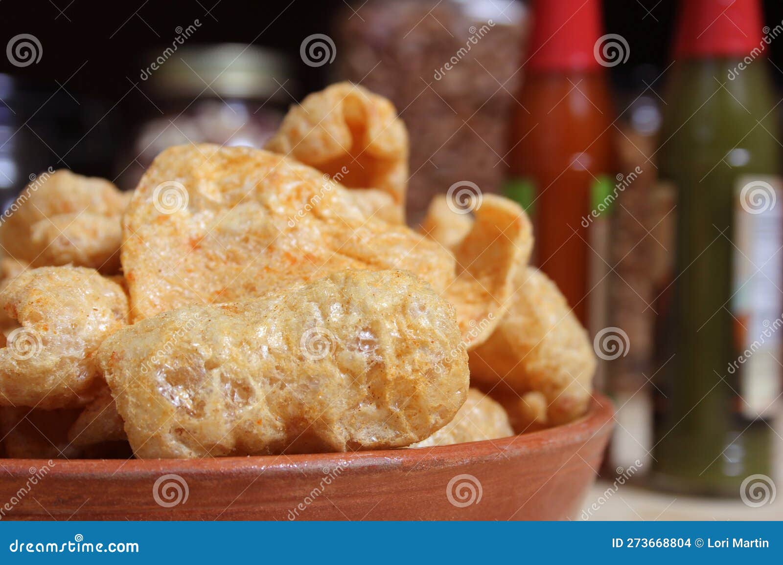 Fried Pork Skins with Hot Sauce in Rustic Kitchen Stock Photo Image