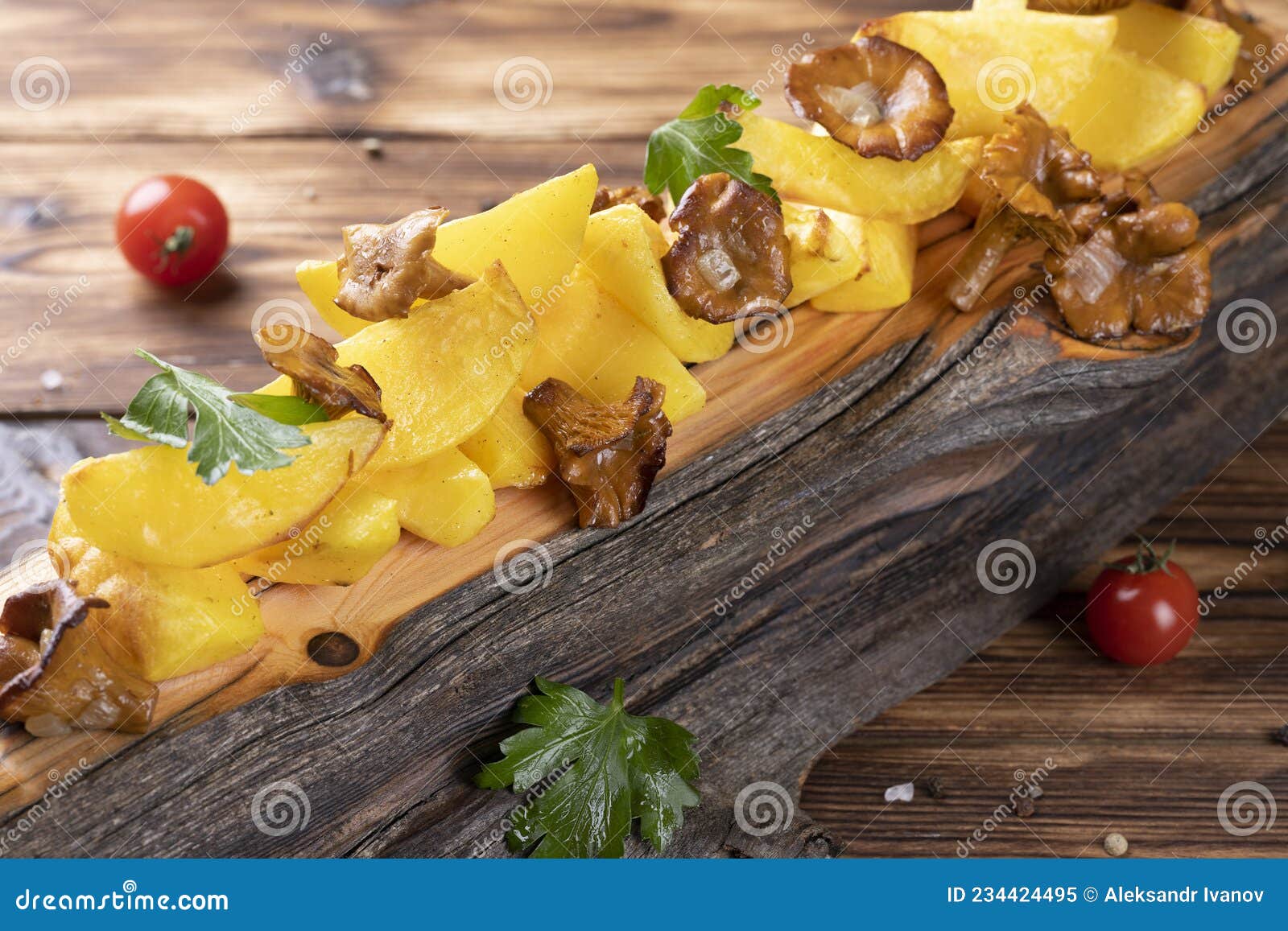 Fried Potatoes with Chanterelles on Wooden Board on the Table Stock