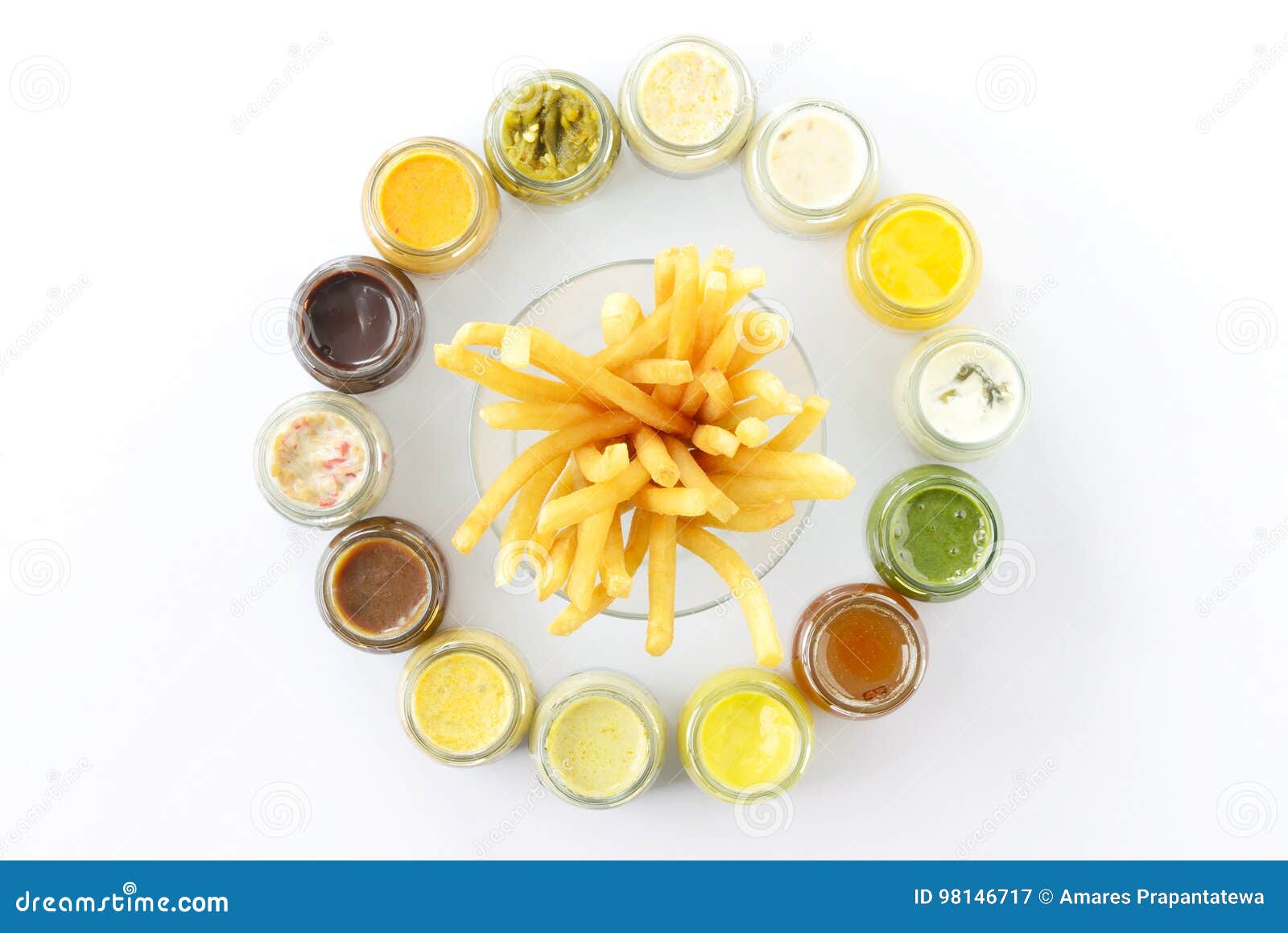 Top View French Fries or Fried Potatoes with Variety Sauce Dips in Bottles on White Floor. Stock