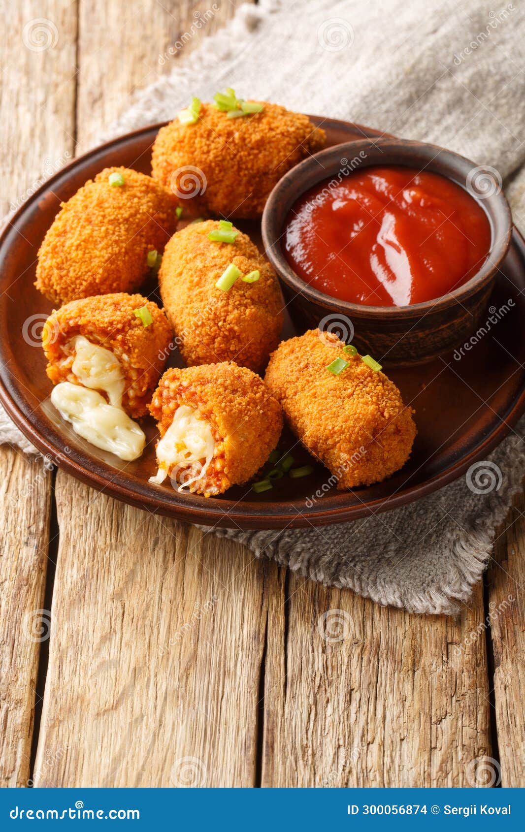 fried rice balls stuffed with mozzarella suppli al telefono closeup on the plate. vertical