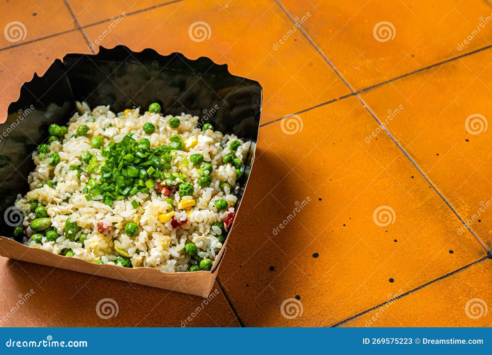 Fried Rice with Egg and Vegetables in Box Take Away. Orange Background