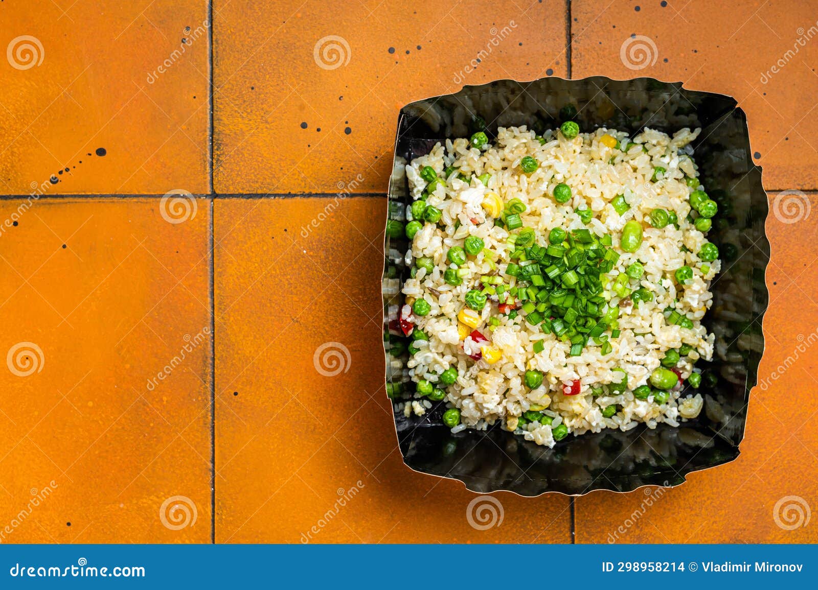 Fried Rice with Egg and Vegetables in Box Take Away. Orange Background