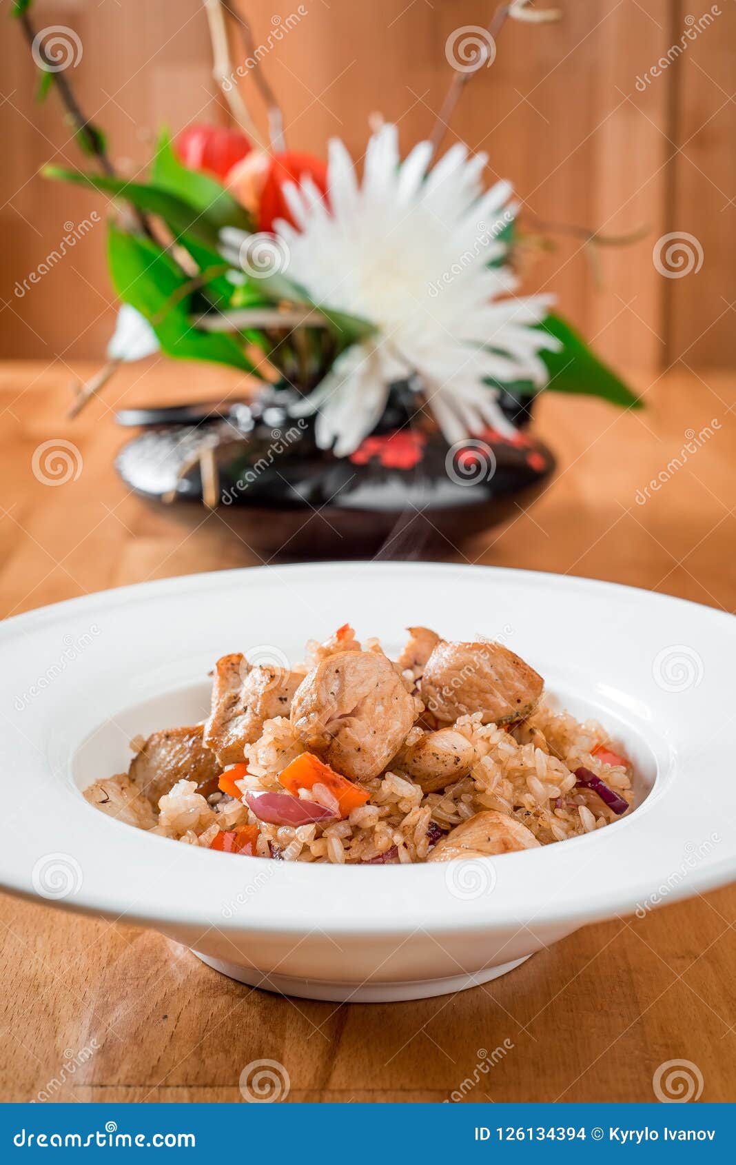 Fried Rice with Meat and Vegetables in a White Plate. Close-up Stock