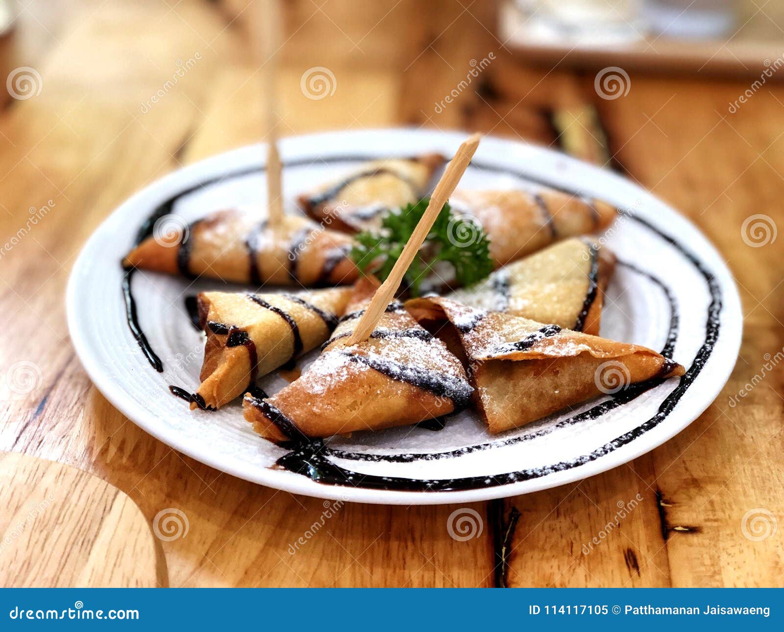 Fried Samosa Banana in White Dish Topped with Icing Sugar Stock Image ...