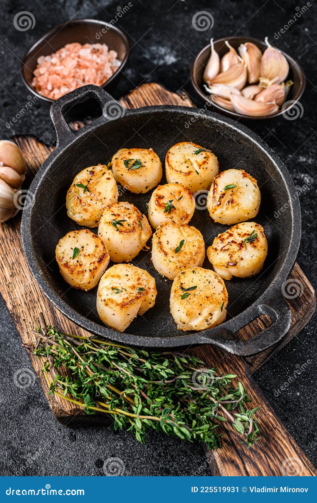 Fried Scallops with Butter Sauce in a Pan. Black Background Stock Image