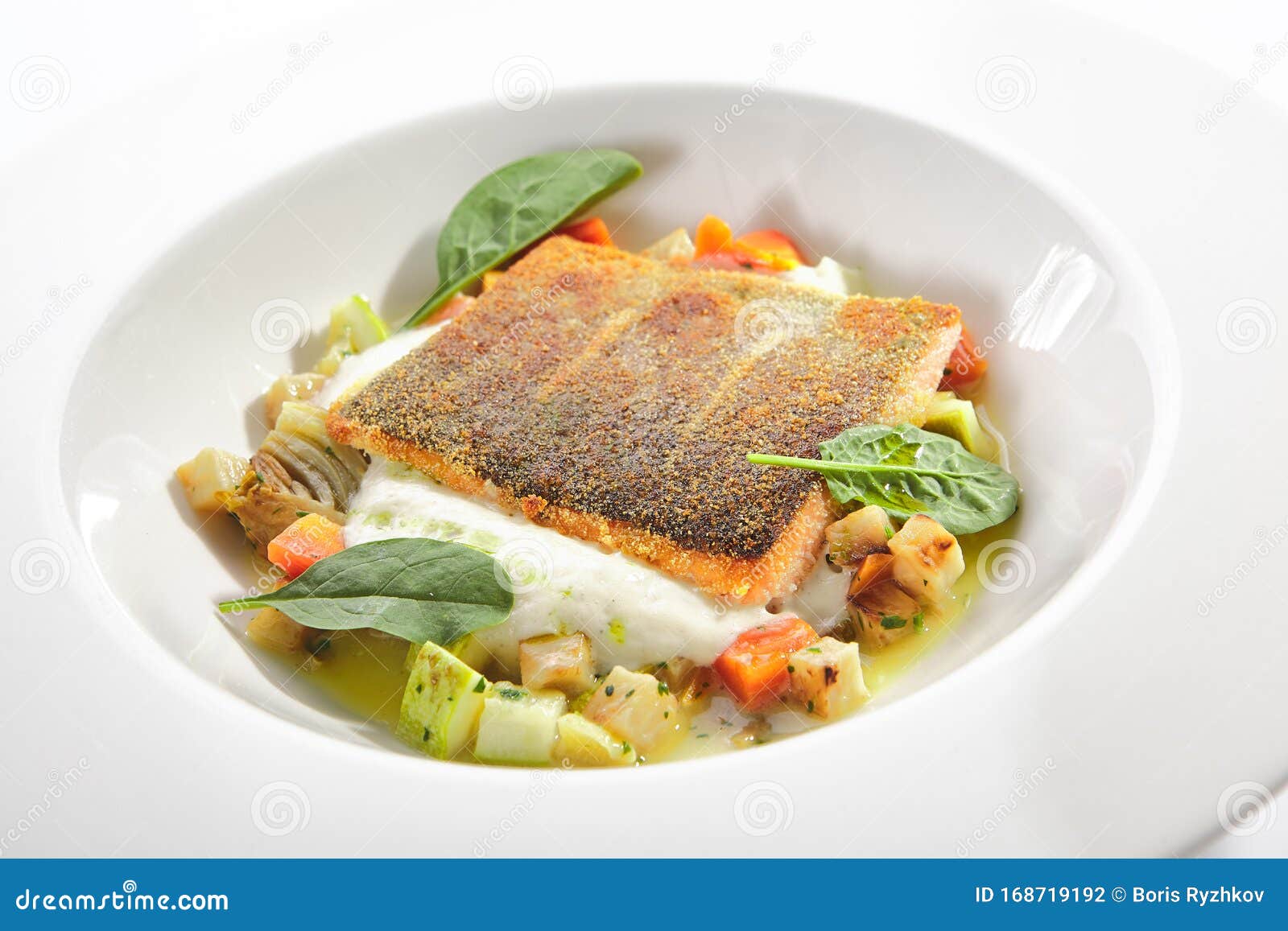 fried trout fillet and vegetable stew with herbs espuma