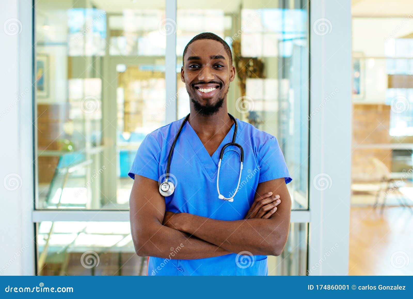 Friendly Male Doctor or Nurse Wearing Blue Scrubs Uniform and