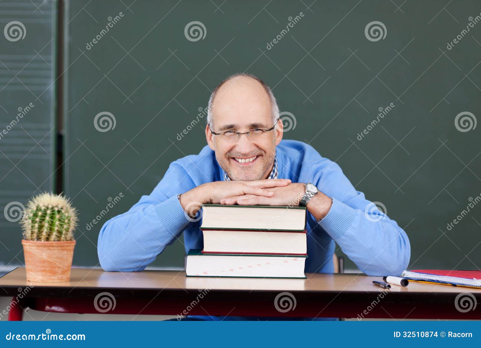 friendly male teacher relaxing classroom front blackboard 32510874