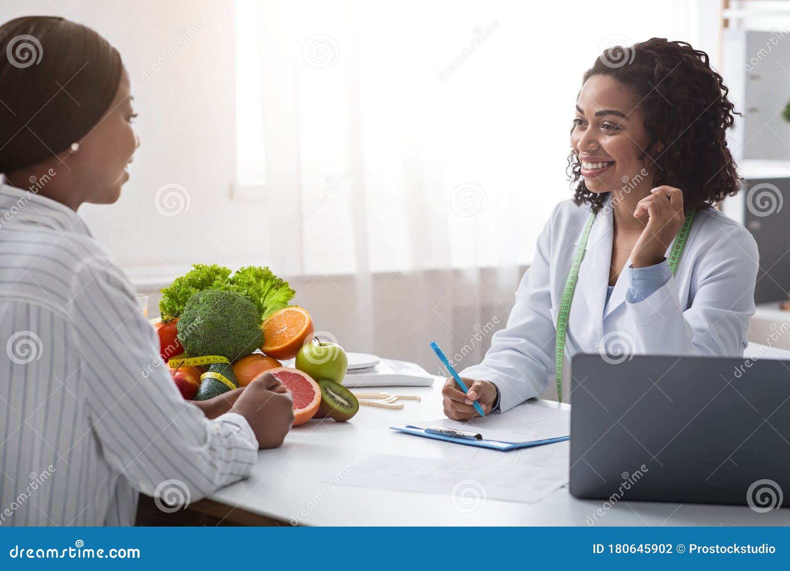 friendly nutritionist giving consultation to patient about healthy feeding