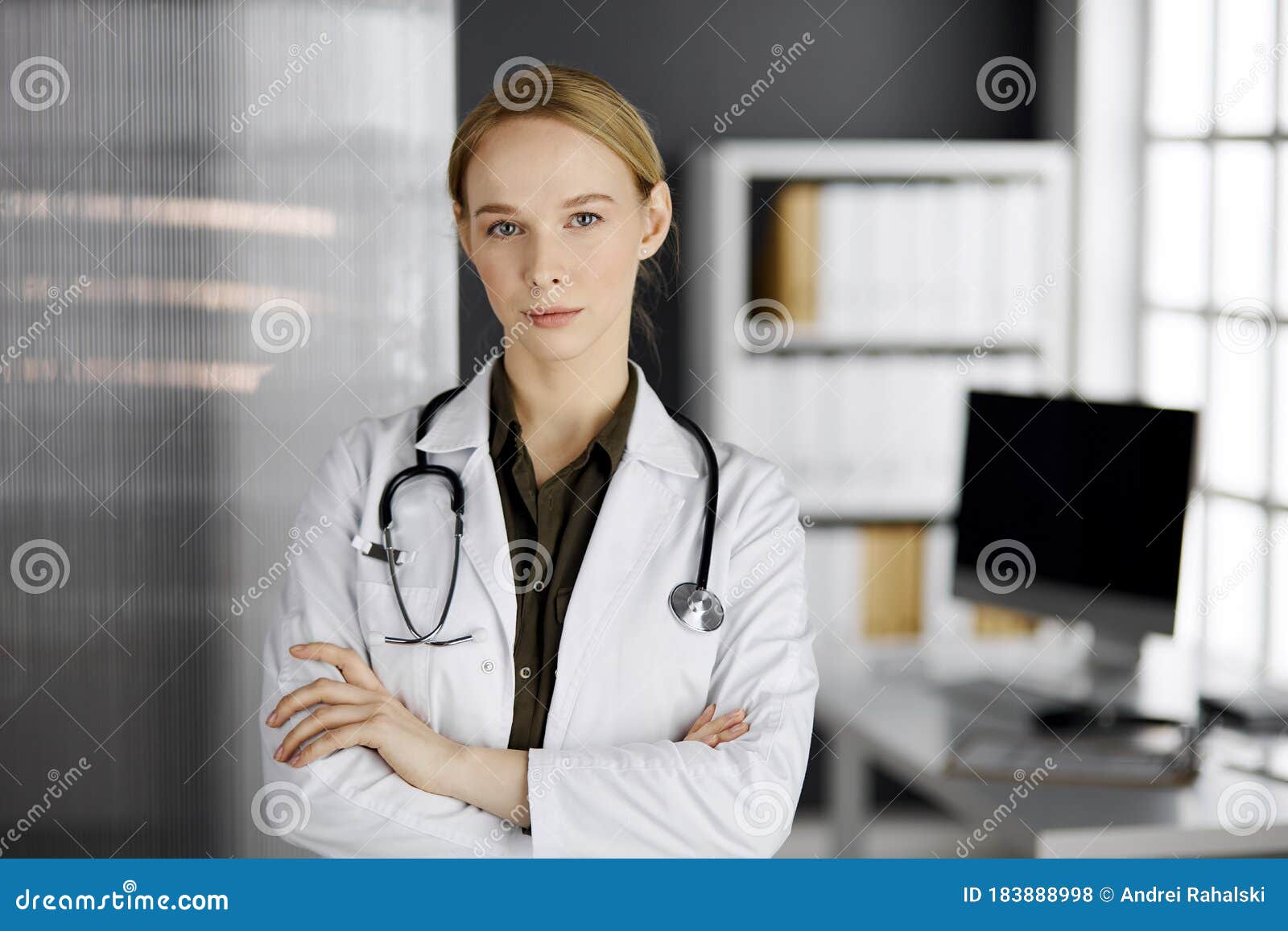 Friendly Smiling Female Doctor Standing In Clinic Portrait Of Friendly