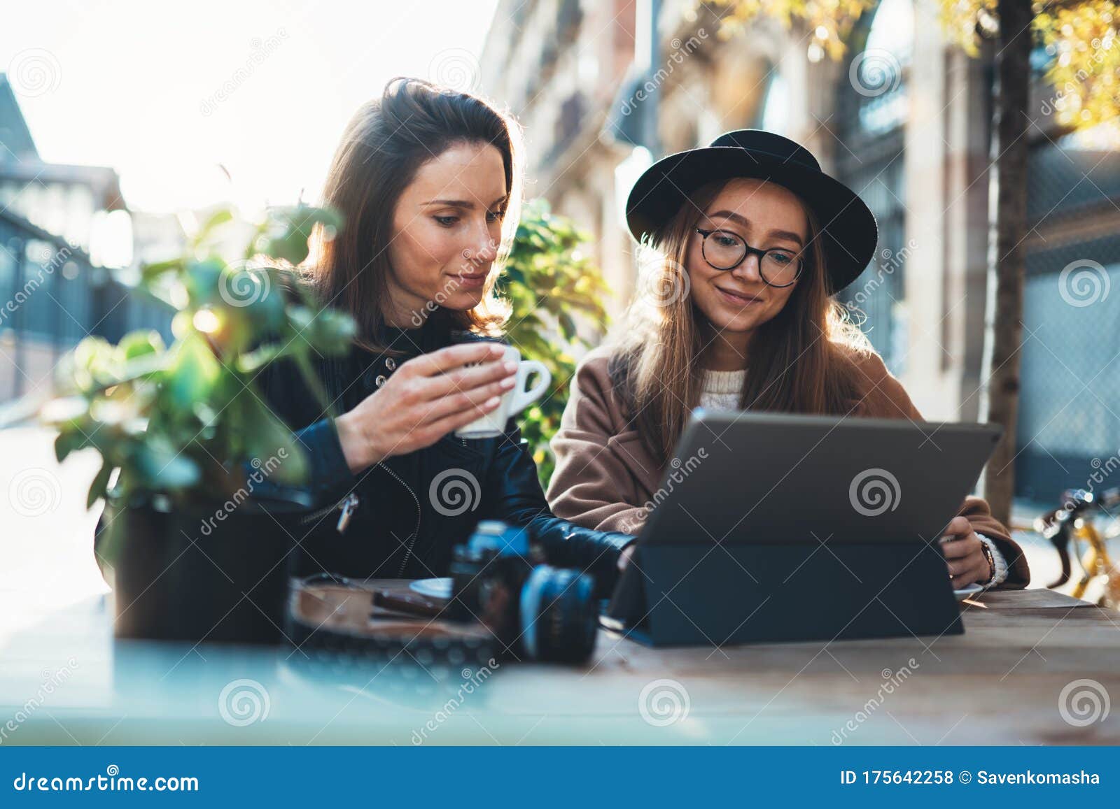 friends businesswoman using digital tablet. girls sitting in cafe. busines communication. internet laptop technology working