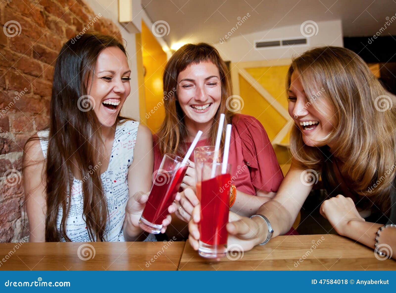 Friends in cafe. Group of friends together in cafe, young girls laughing and celebrating