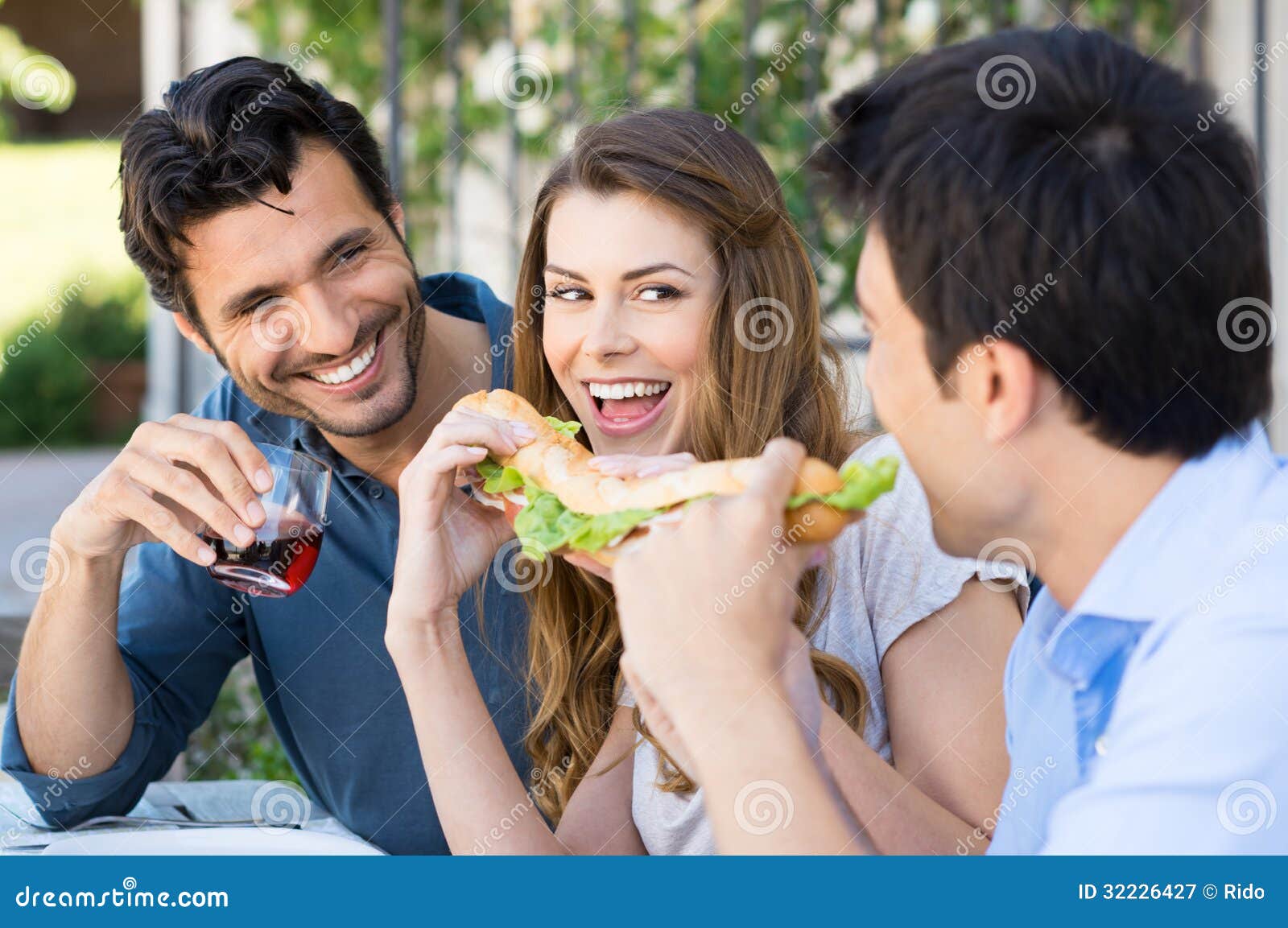 friends-eating-sandwich-happy-group-fun-outdoor-32226427.jpg