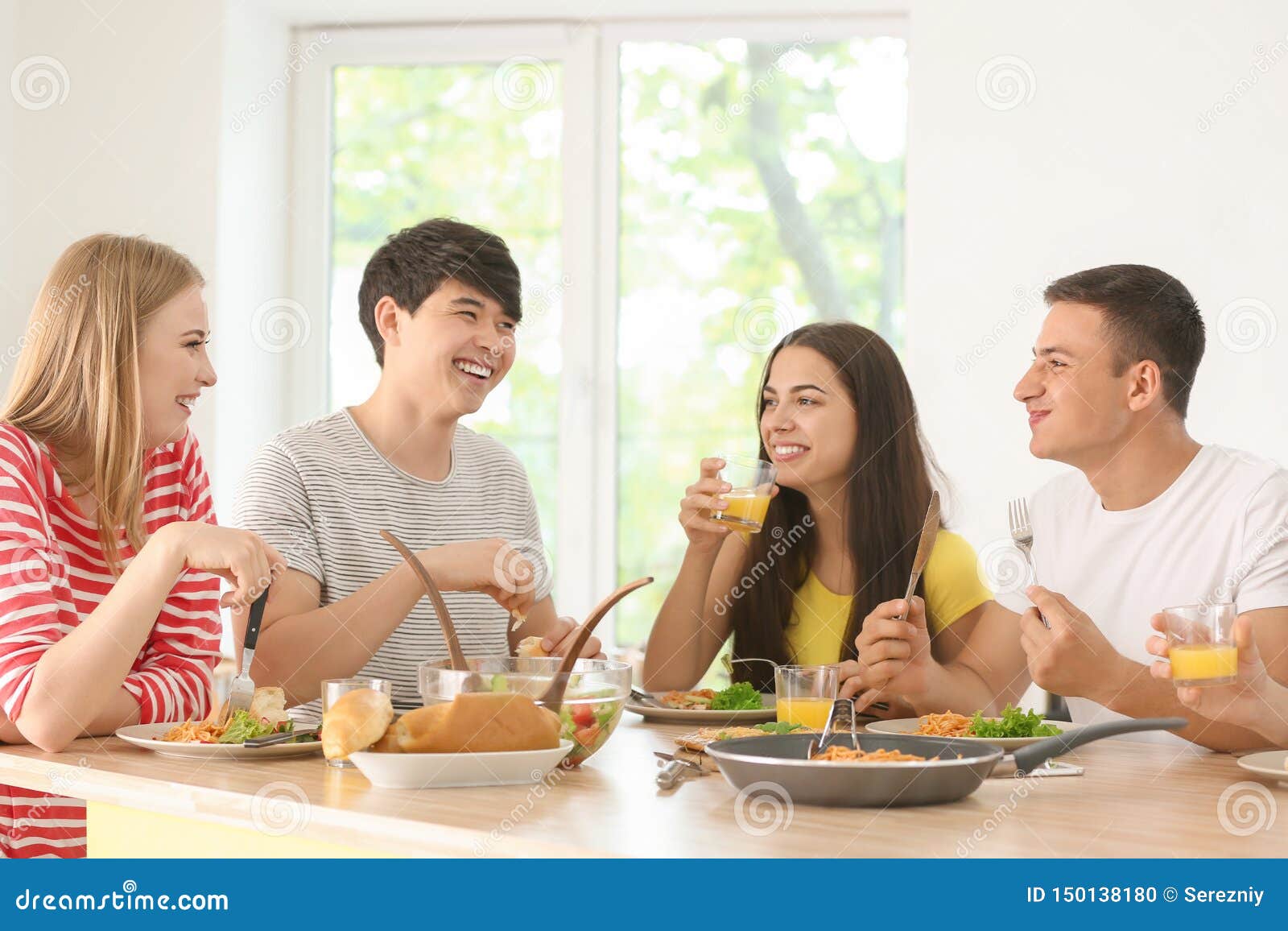 Friends Eating at Table in Kitchen Stock Photo Image of juice