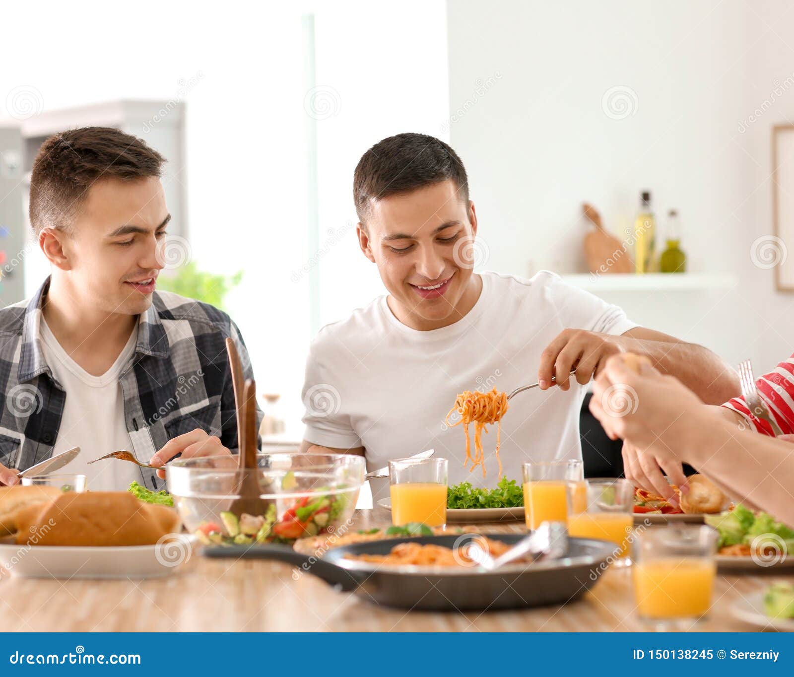 Friends Eating at Table in Kitchen Stock Image Image of indoors