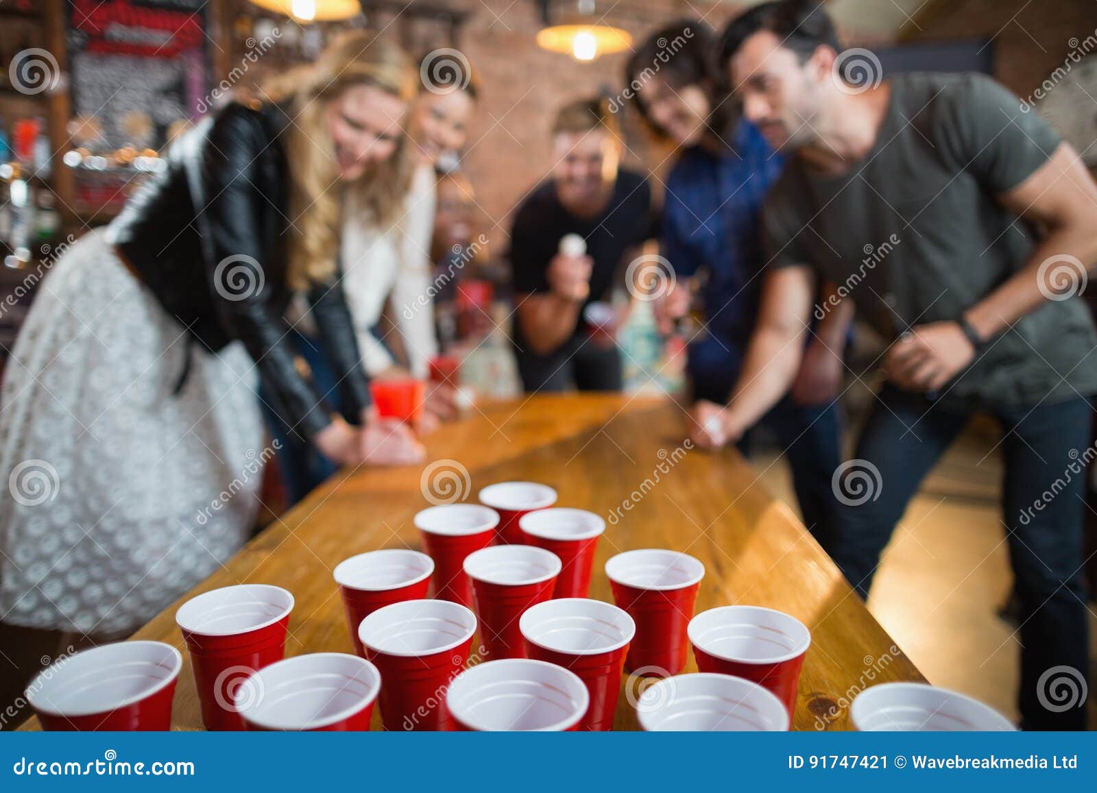 Friends Enjoying Beer Pong Game in Bar Stock Image Image of glass, adult 91747421