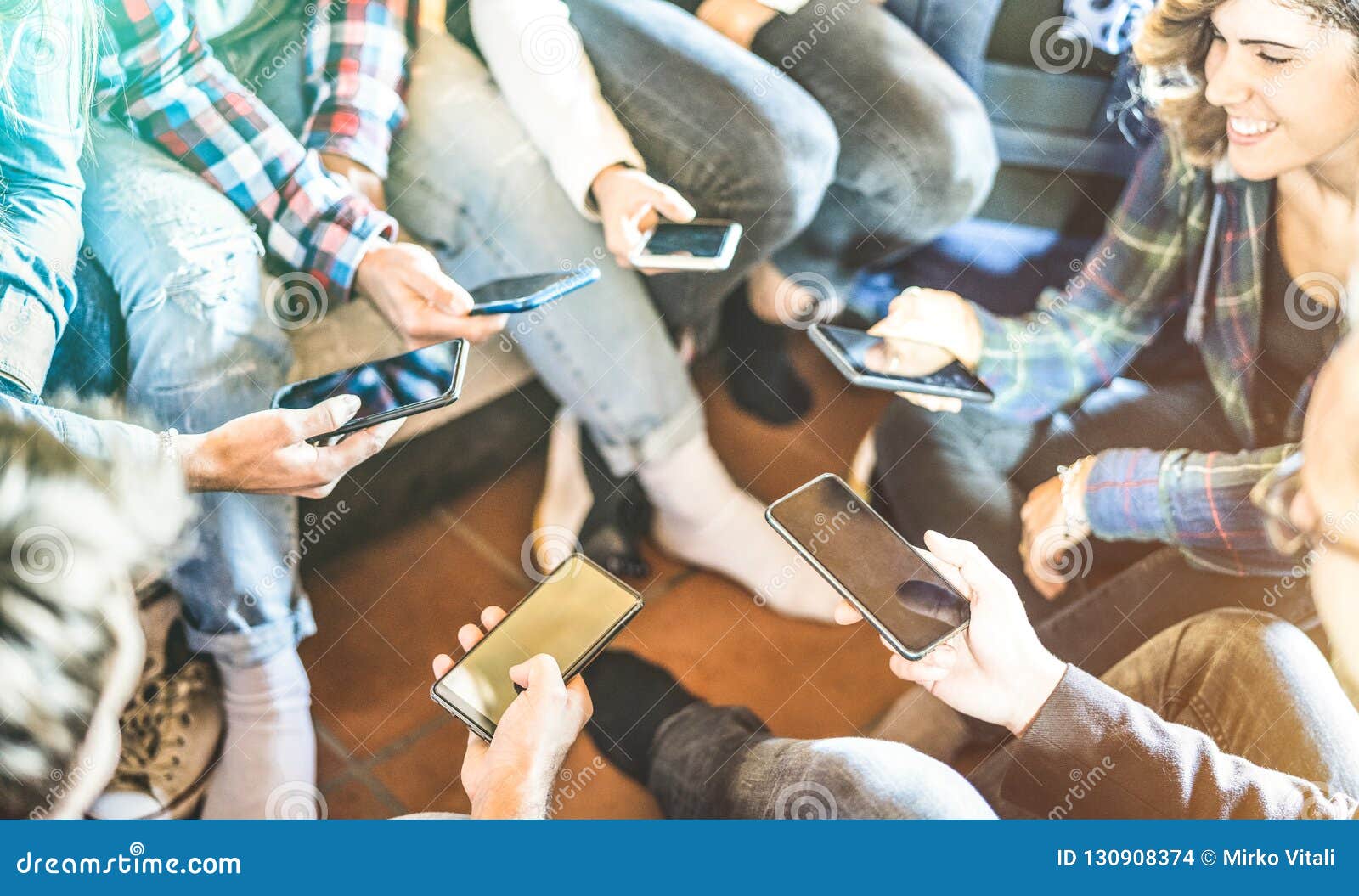 friends group having addicted fun together using mobile smart phones